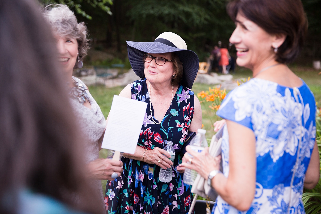 A documentary photograph of guests talking during cocktail hour at a Friendly Crossways Wedding