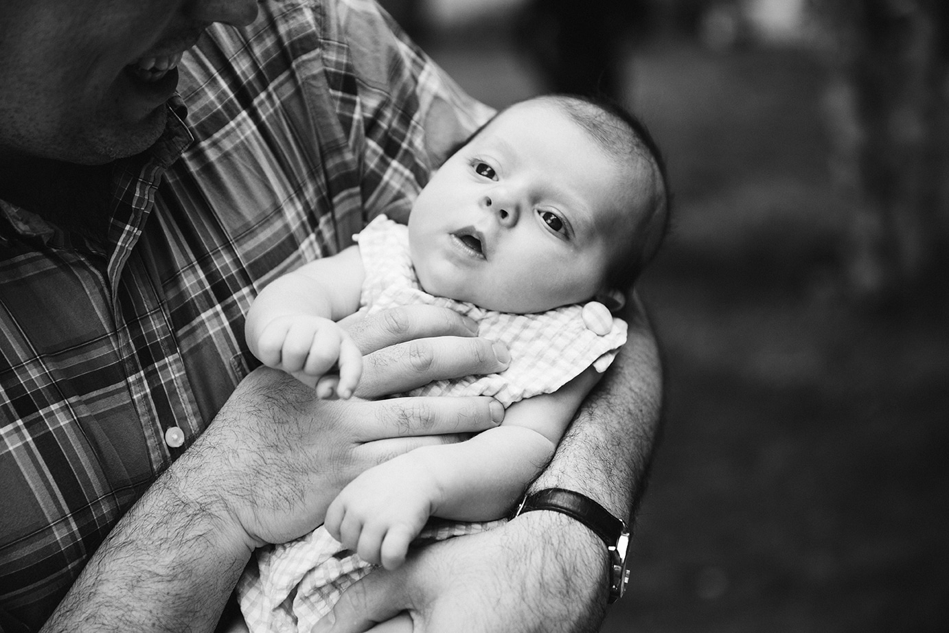 A documentary photograph of guests holding a baby during a Friendly Crossways Wedding