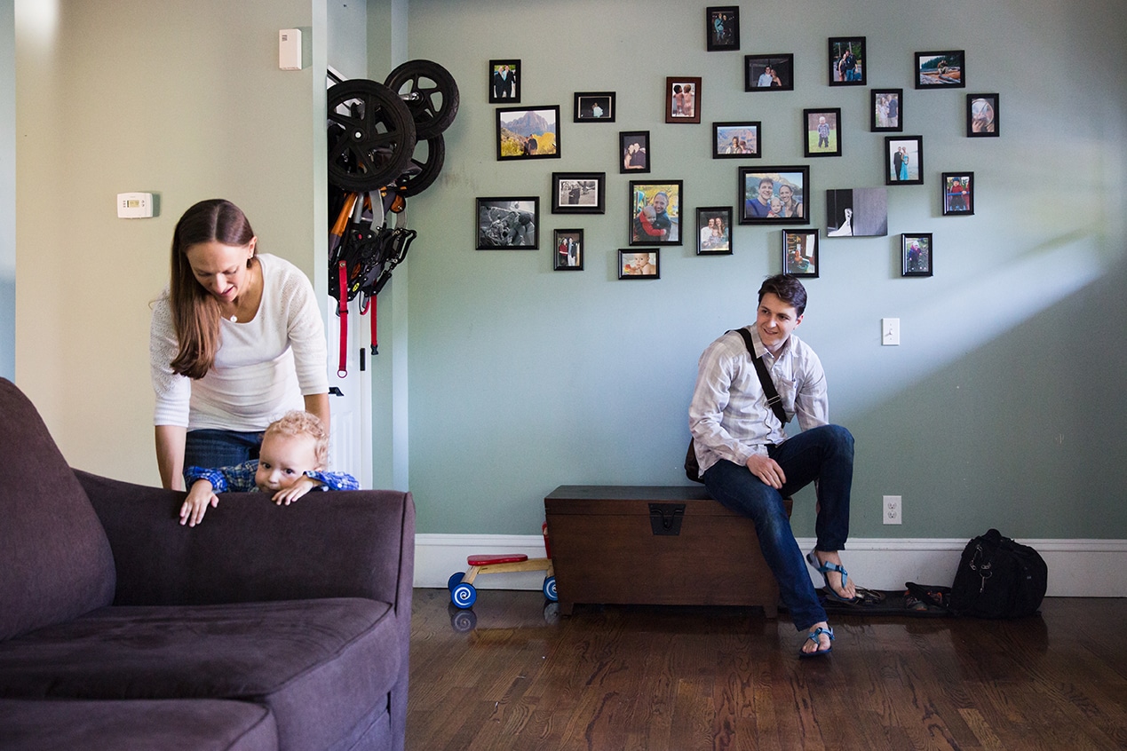 A lifestyle photograph of family in the living room during their in home family session in Boston
