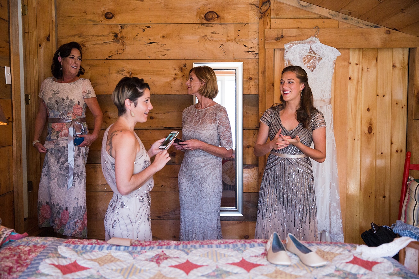 A documentary photograph of bridesmaids getting ready before a Kingsley Pines Camp Wedding in Maine