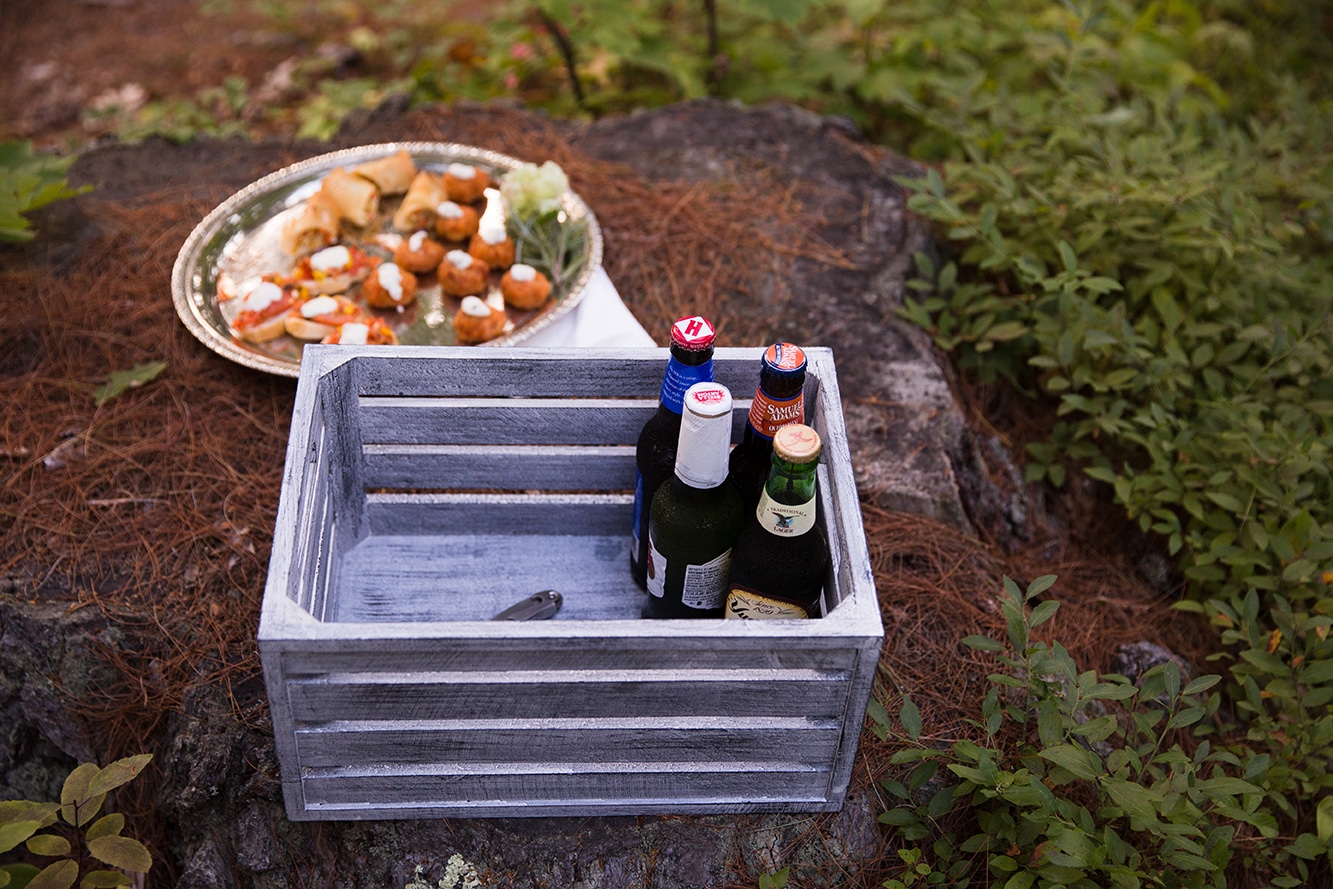 A detailed photograph of craft beer and food at a Kingsley Pines Camp wedding in Maine