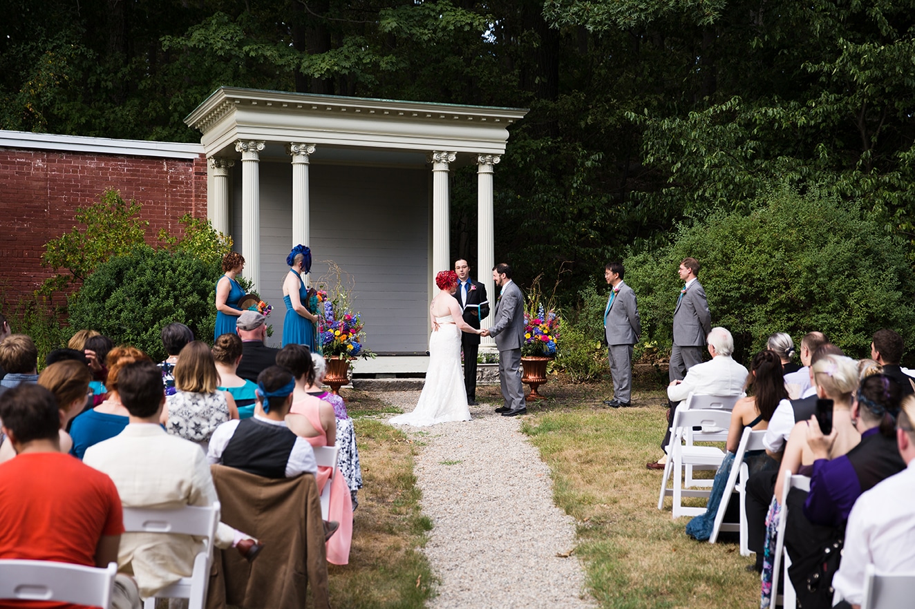 A documentary photograph of a bride and groom saying their vows during an Lyman Estate Wedding in Boston, Massachusetts