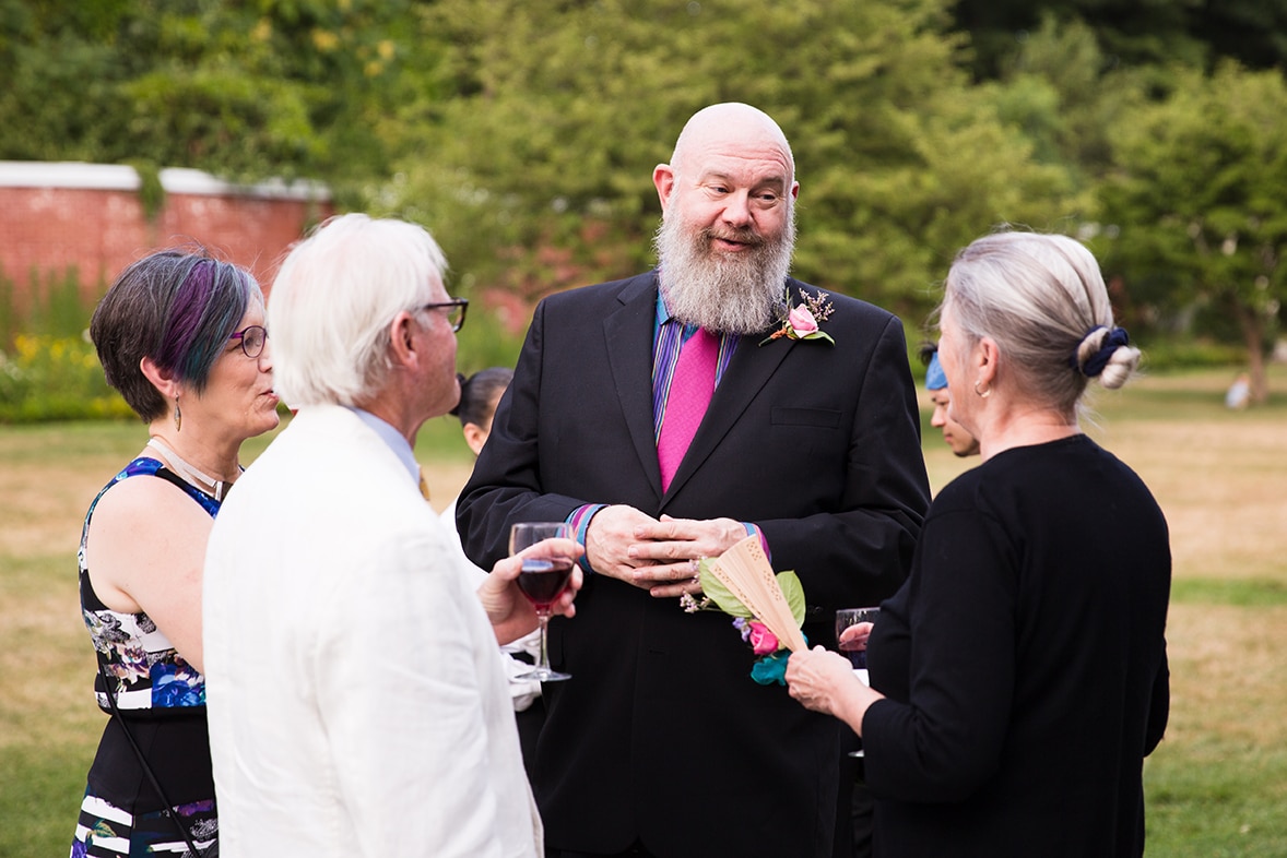 A documentary photograph of guests laughing and talking during the cocktail hour of a Lyman Estate Wedding in Boston, Massachusetts