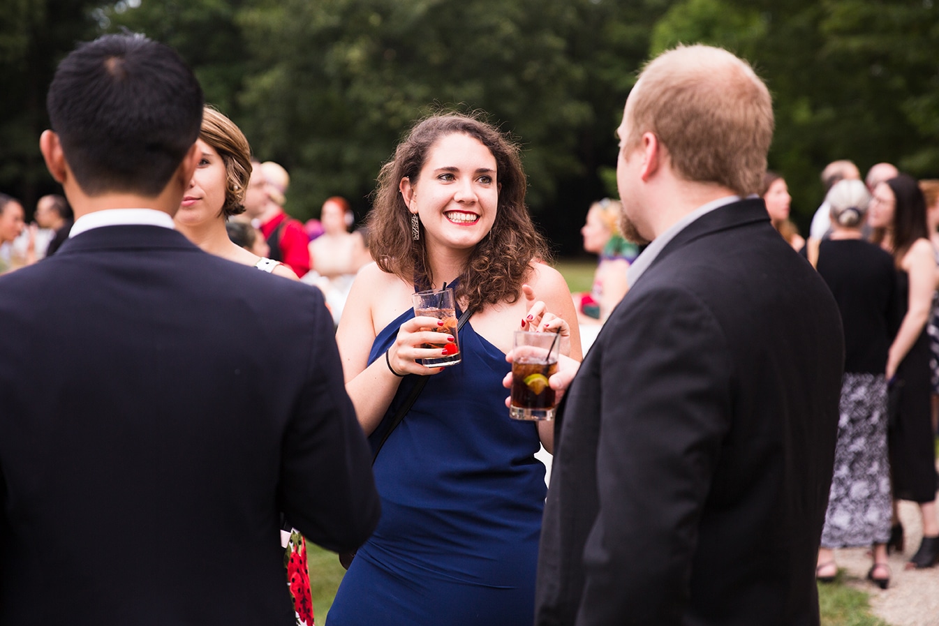 A documentary photograph of guests talking during the cocktail hour of a Lyman Estate Wedding in Boston, Massachusetts