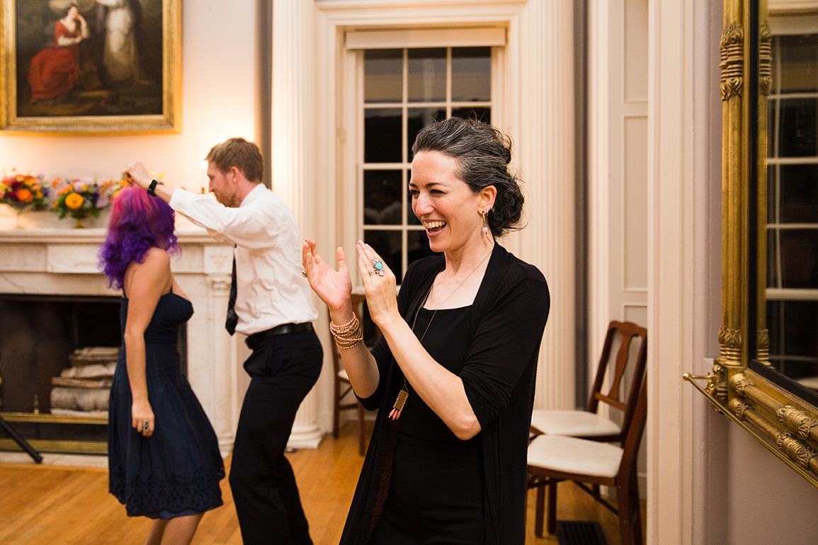A documentary photograph of guests dancing and clapping during a Lyman Estate Wedding in Boston, Massachusetts