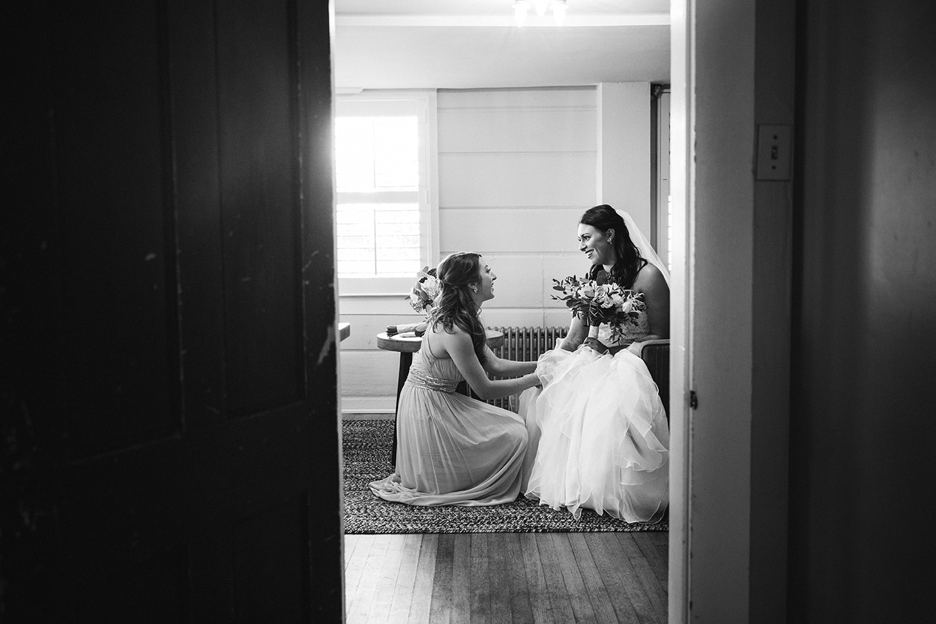 This documentary photograph of bride and bridesmaid talking before the ceremony is one of the best wedding photographs of 2016
