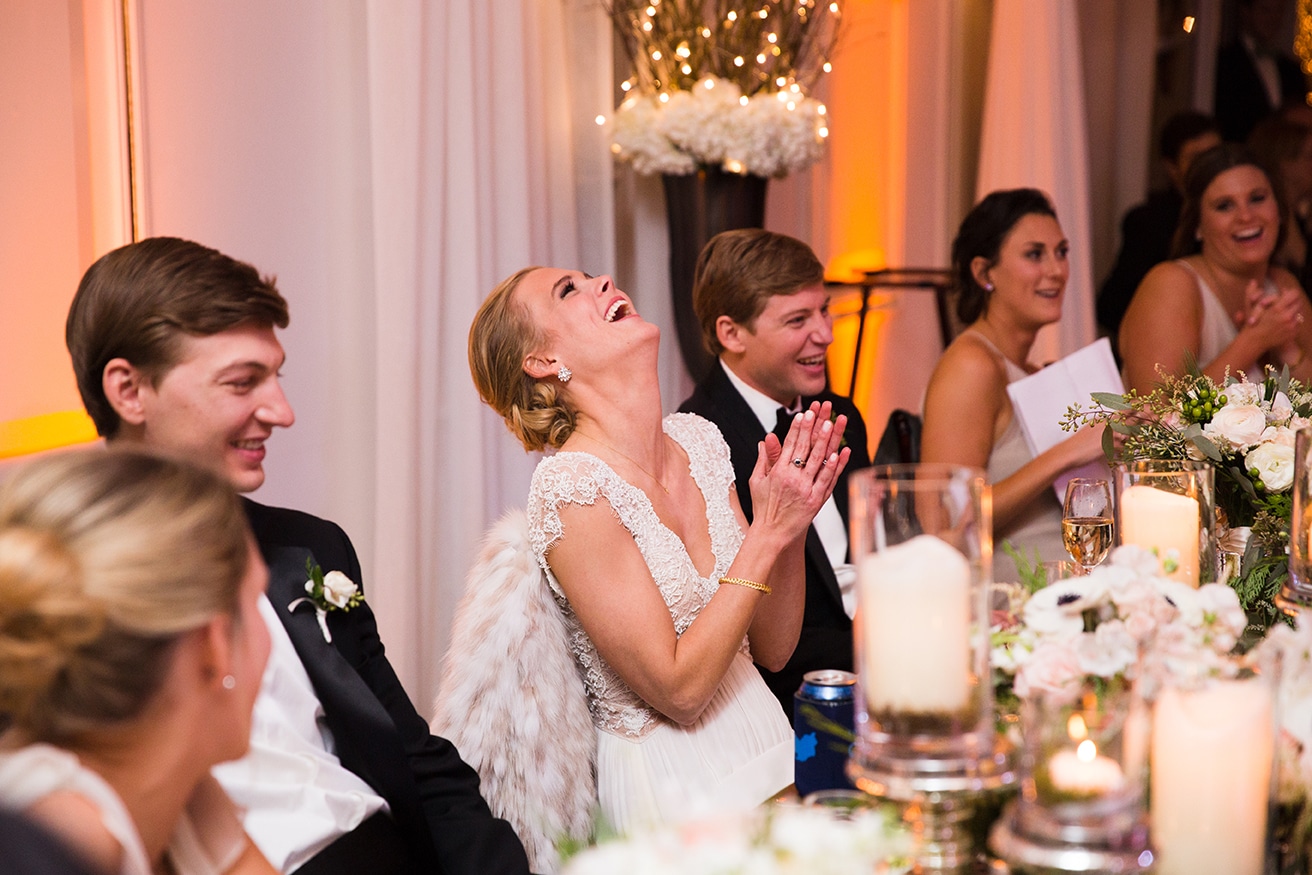 This documentary photograph of a bride laughing during the wedding toasts is one of the best wedding photographs of 2016