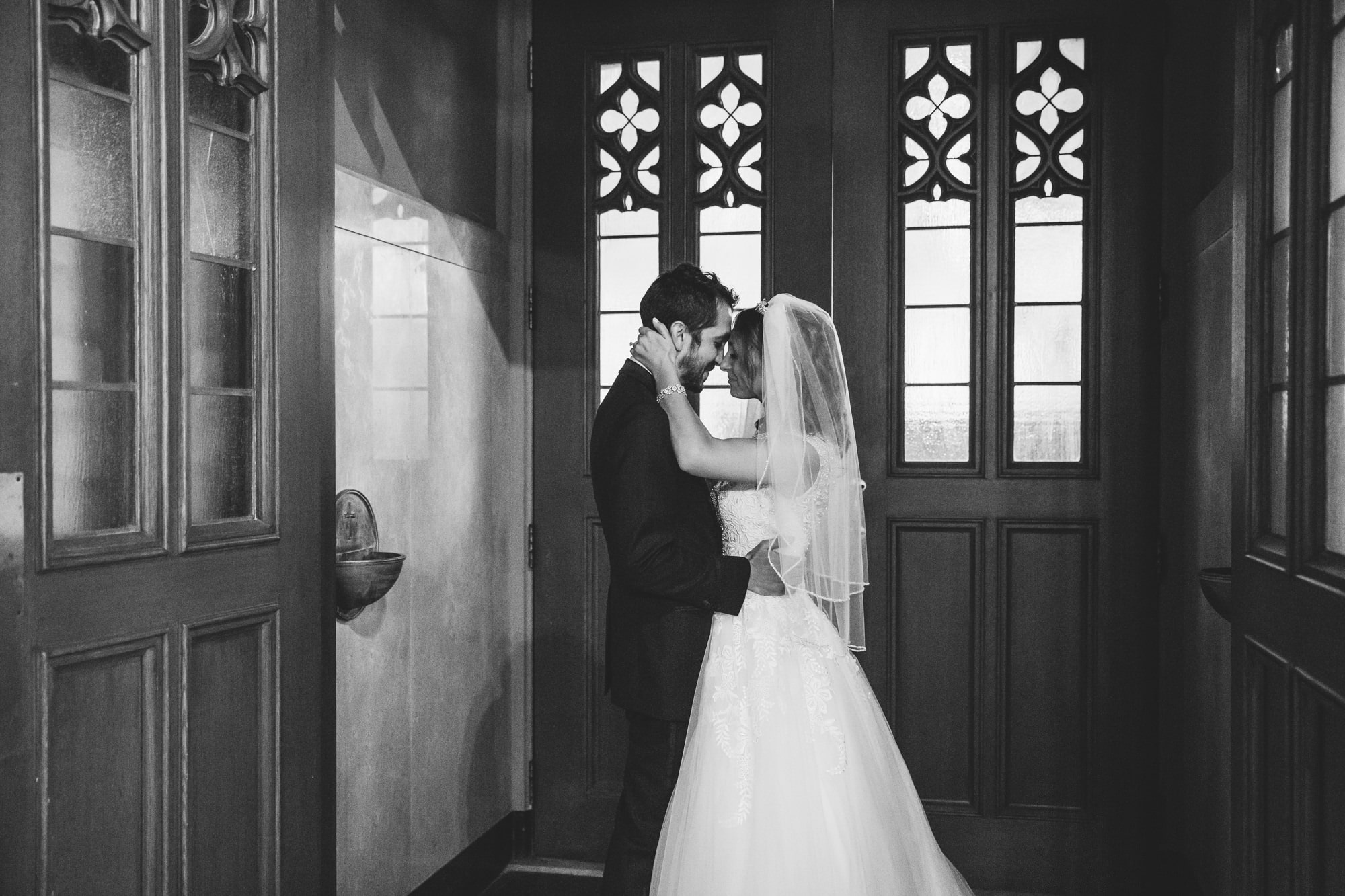 This documentary photograph of a bride and groom sharing an intimate moment after their ceremony is one of the best wedding photographs of 2016