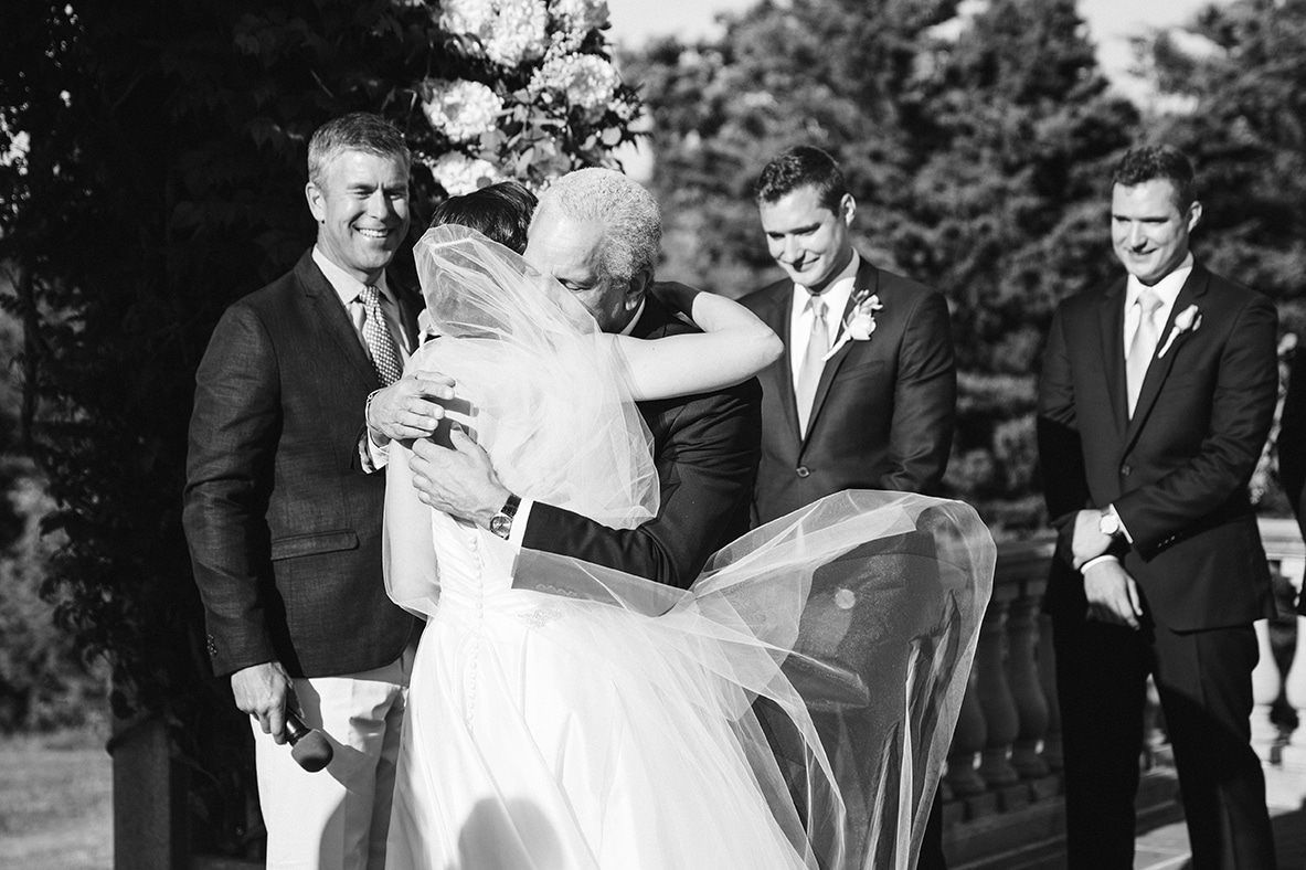 This documentary photograph of a bride hugging her father at the alter is one of the best wedding photographs of 2016