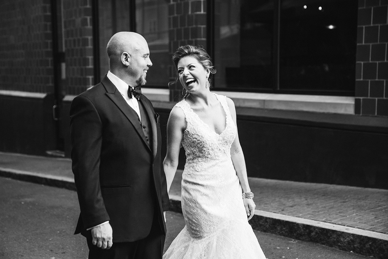 This documentary photograph of a bride and groom laughing together is one of the best wedding photographs of 2016