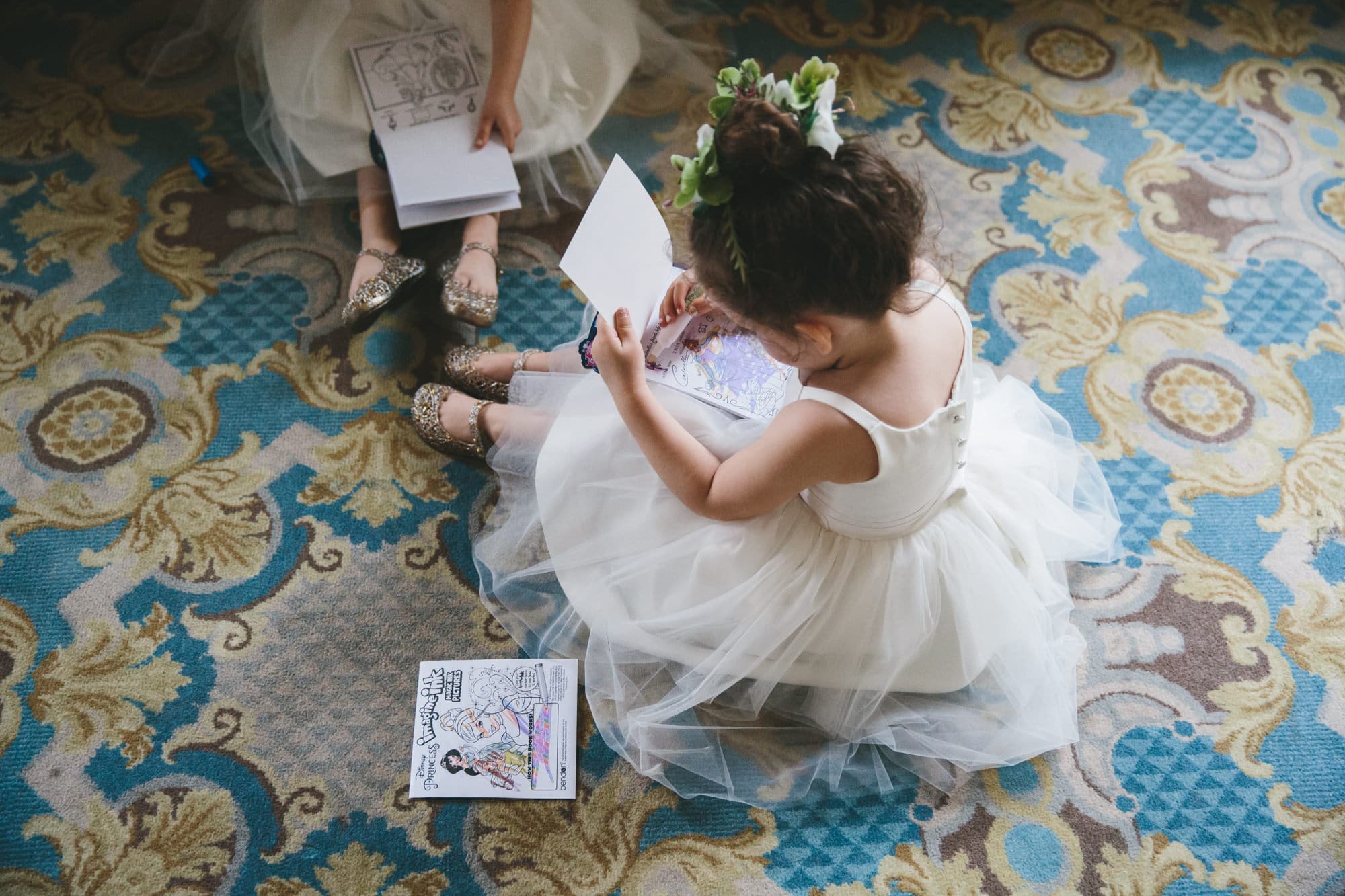 This documentary photograph of flower girls coloring at Taj Boston Wedding is one of the best wedding photographs of 2016