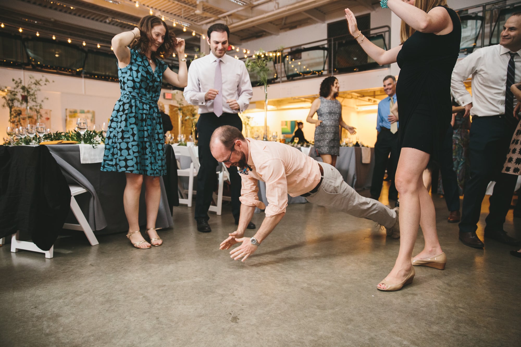 This photojournalistic photograph of guests dancing at an Artists for Humanity wedding is one of the best wedding photographs of 2016