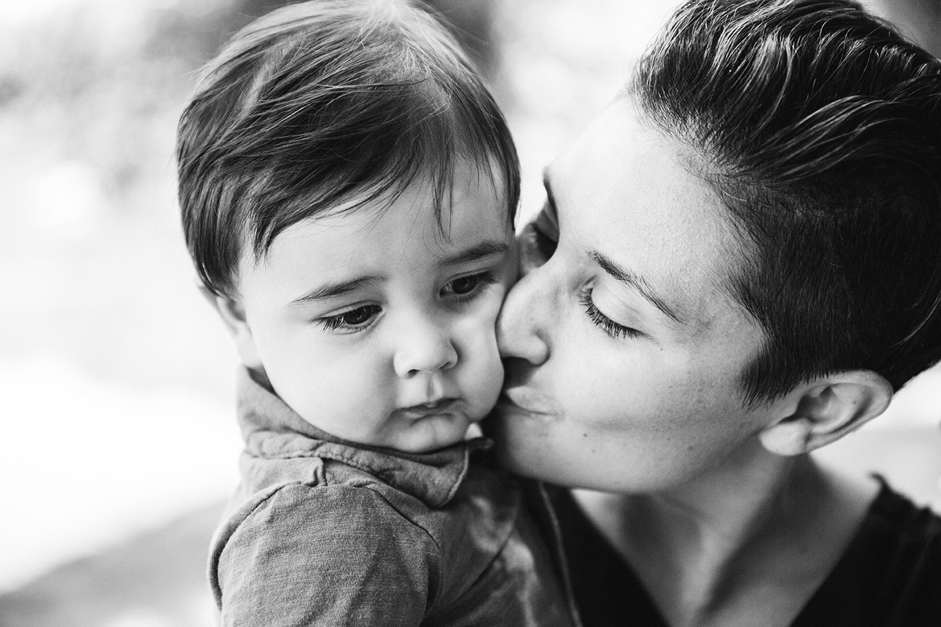 This documentary photograph of a mother kissing her son is one of the best family photographs of 2016