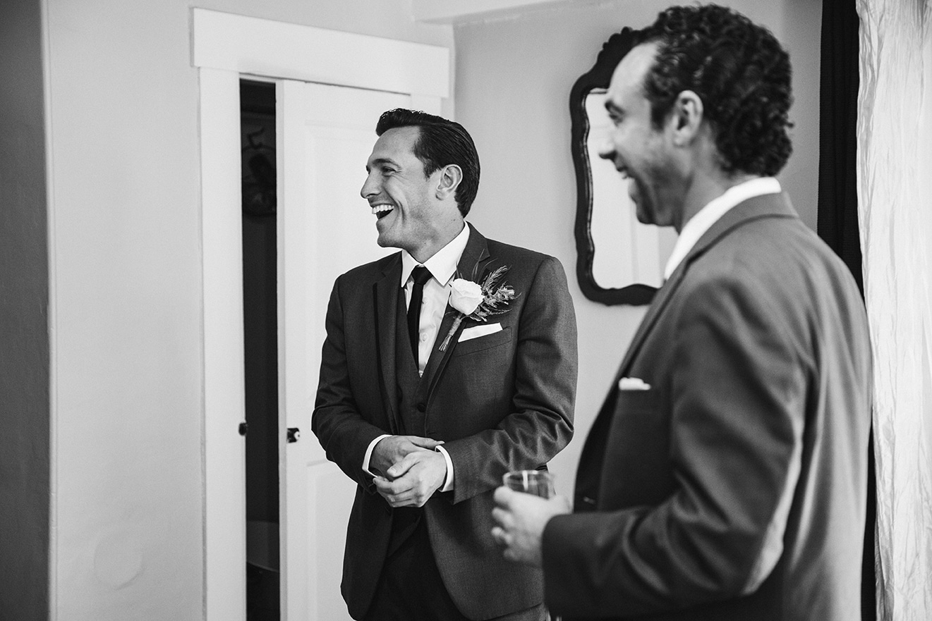 This documentary photograph of a groom laughing before his harrington farm wedding is one of the best wedding photographs of 2016