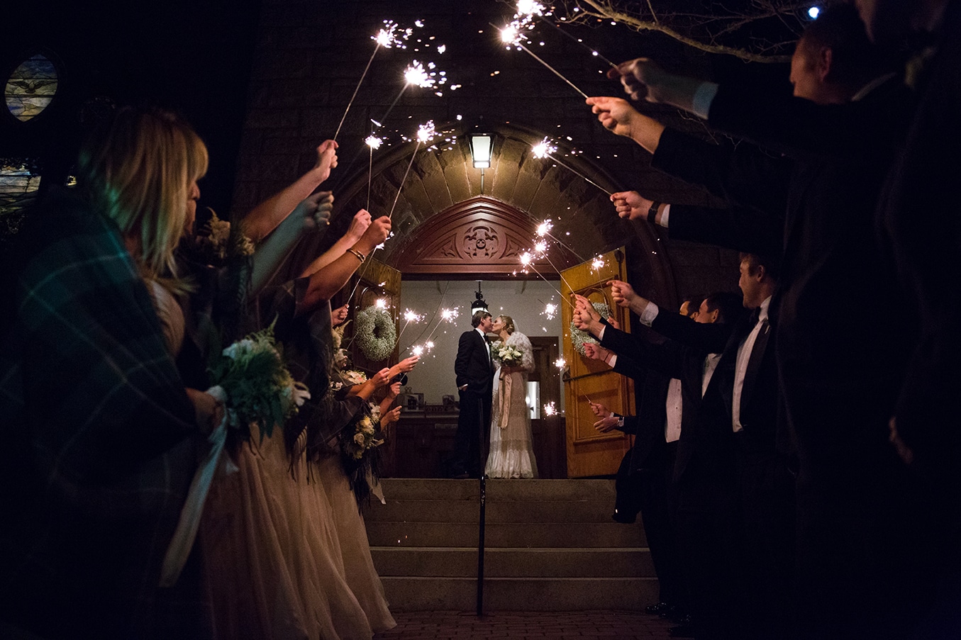This documentary photograph of a bride and groom leaving the church through a sparkler exit is one of the best wedding photographs of 2016