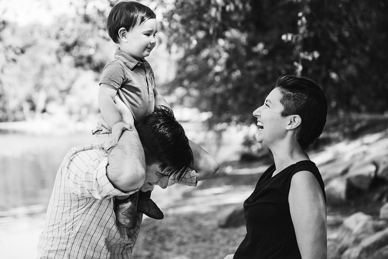 A lifestyle portrait of a family laughing together during their Jamaica Pond family session in Boston, Massachusetts