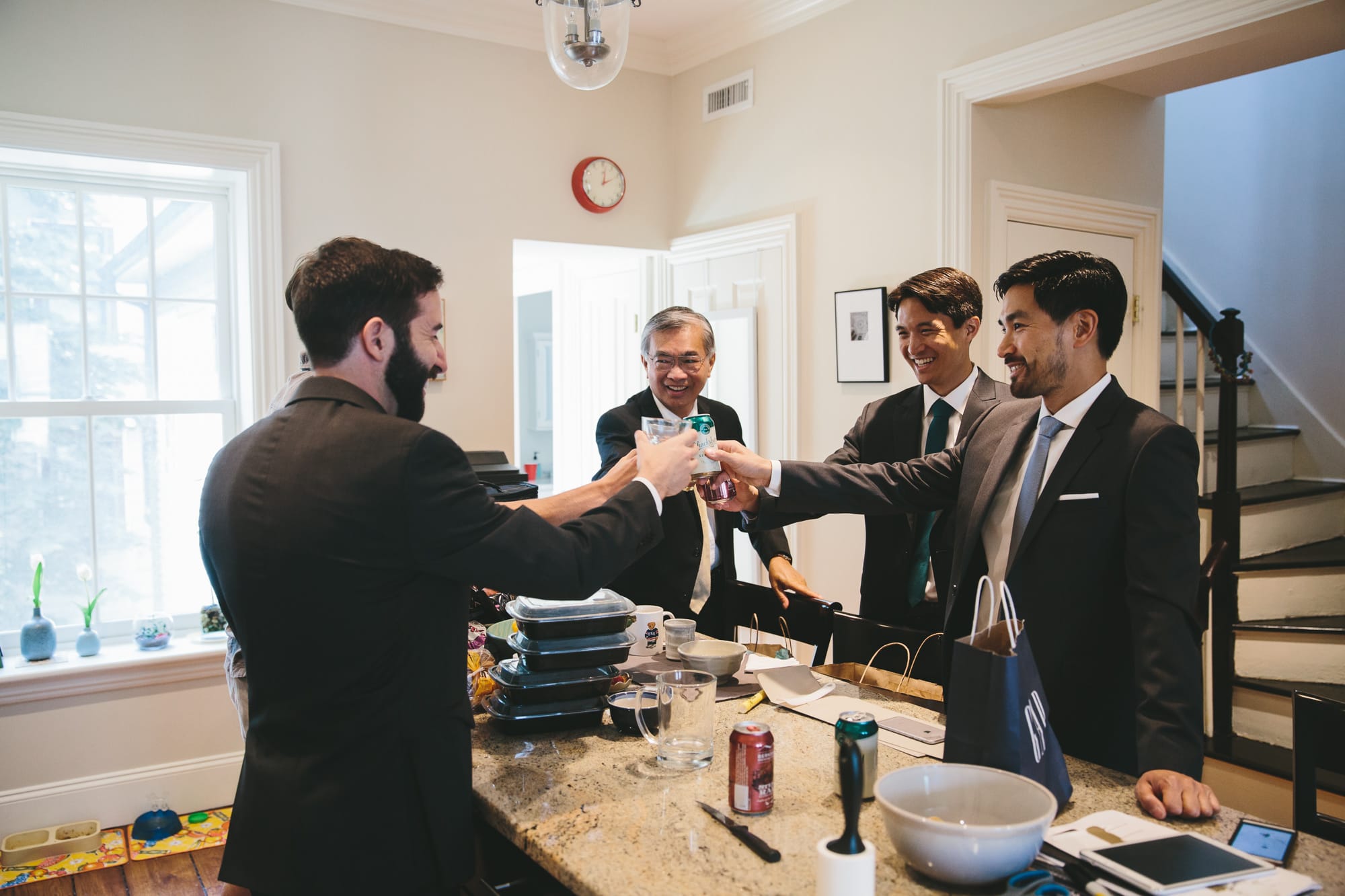 A documentary photograph of a groom and his groomsmen sharing a toast before his Artists for Humanity Wedding in Boston, Massachusetts