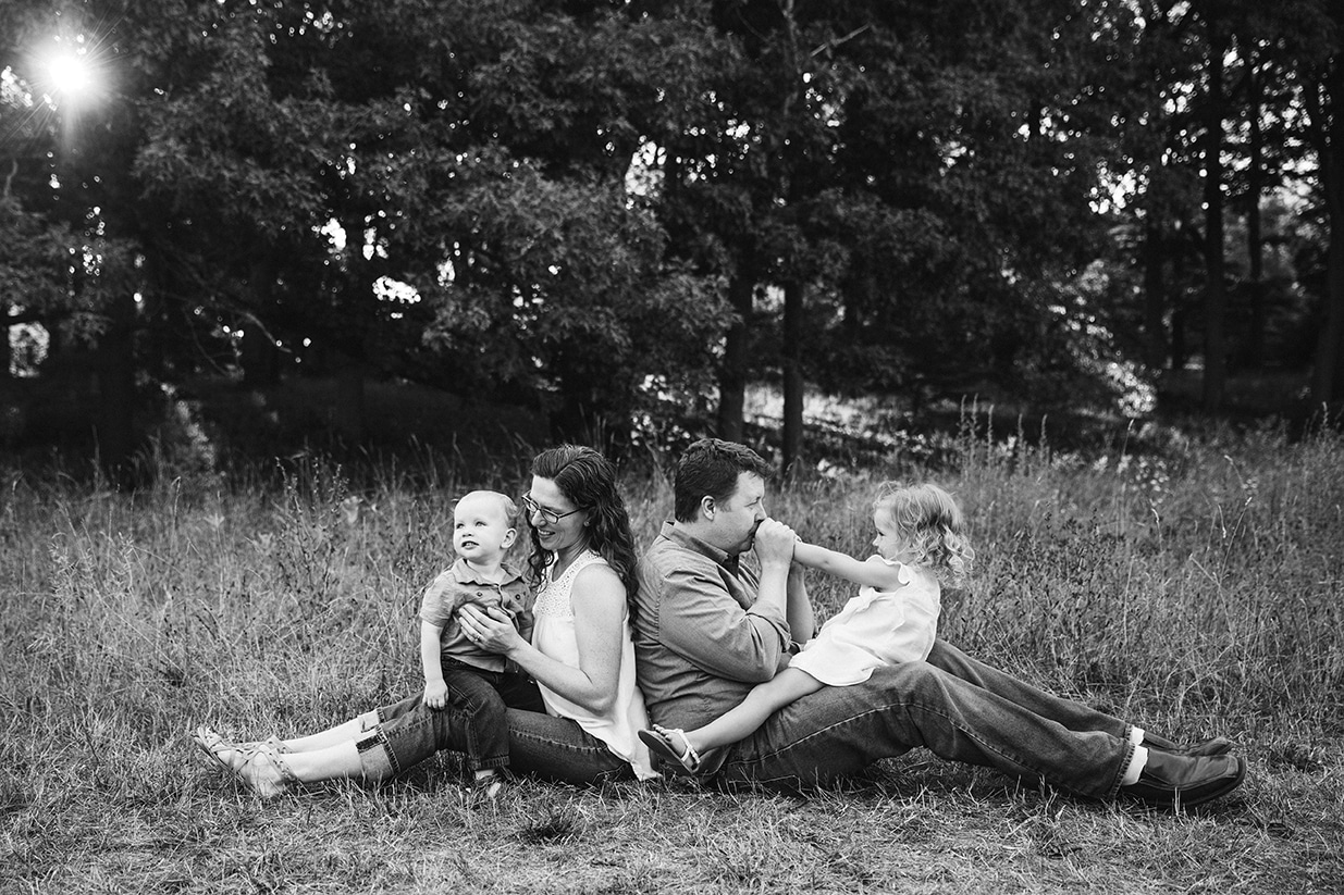 A documentary photograph of family playing together during their Arnold Arboretum family session in Boston, Massachusetts