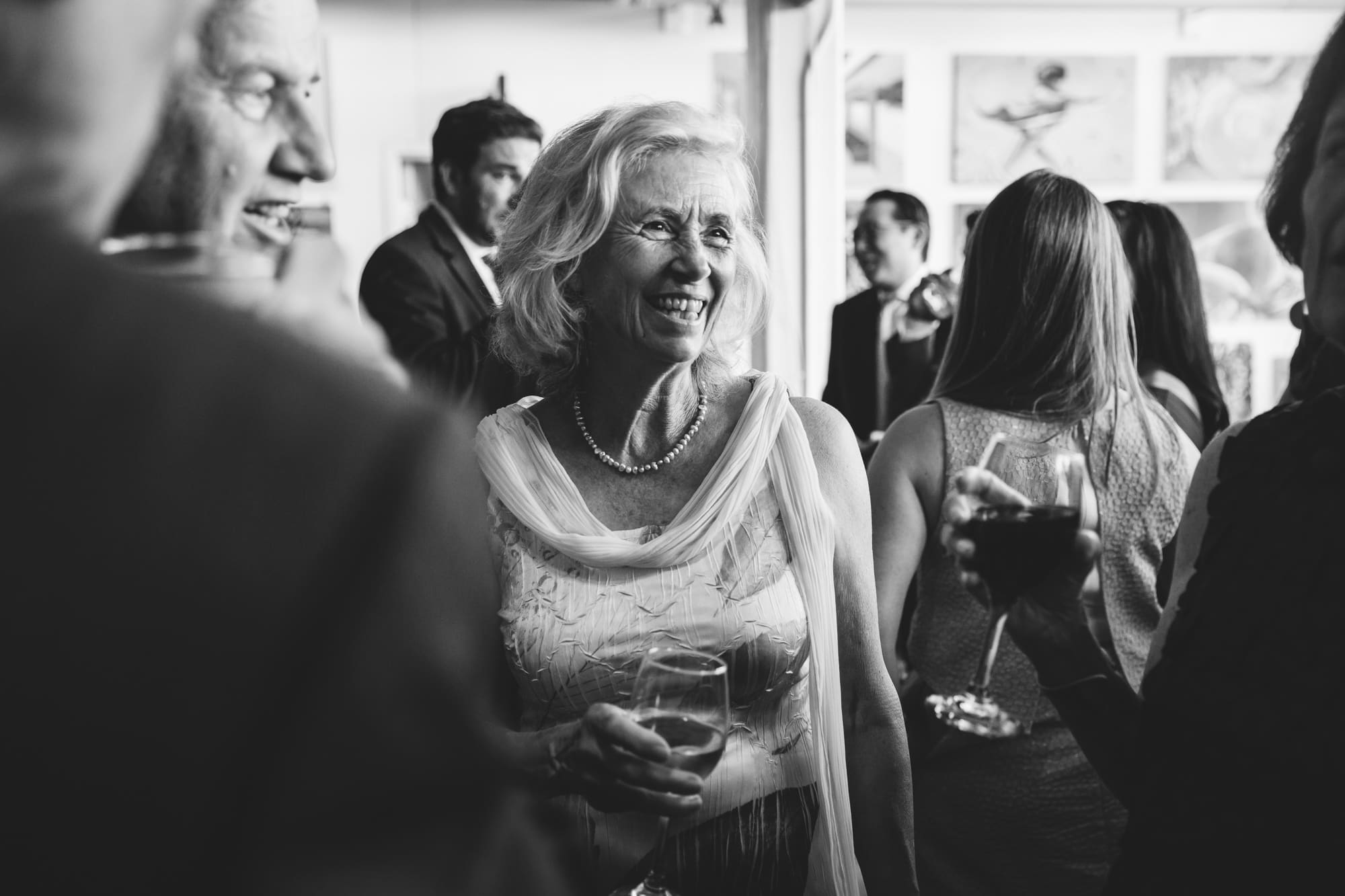 A documentary photograph of guest talking during an Artists for Humanity Wedding in Boston