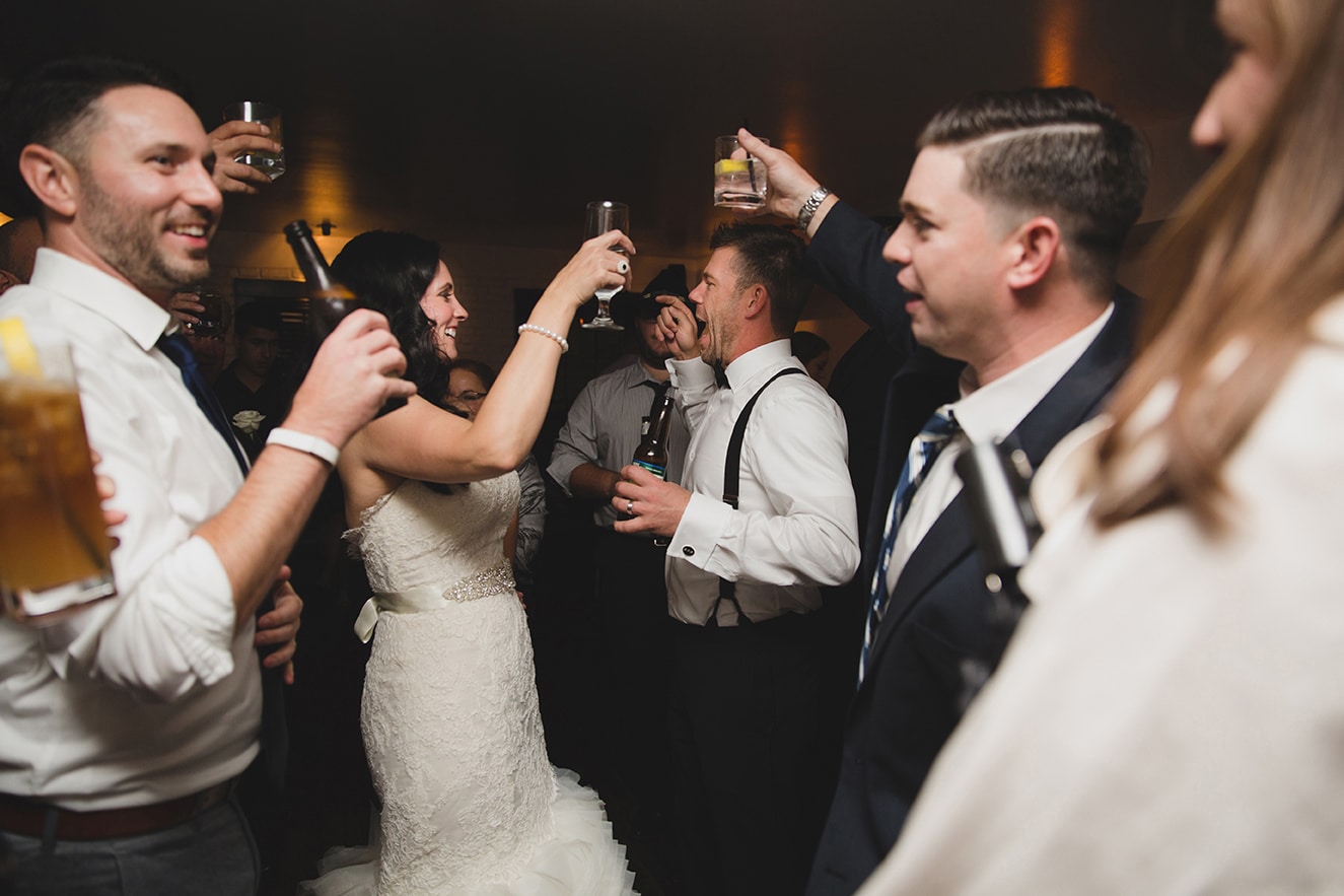 A documentary photograph of a couple dancing and celebrating with friends during their old south meeting house and marliave wedding in Boston, Massachusetts