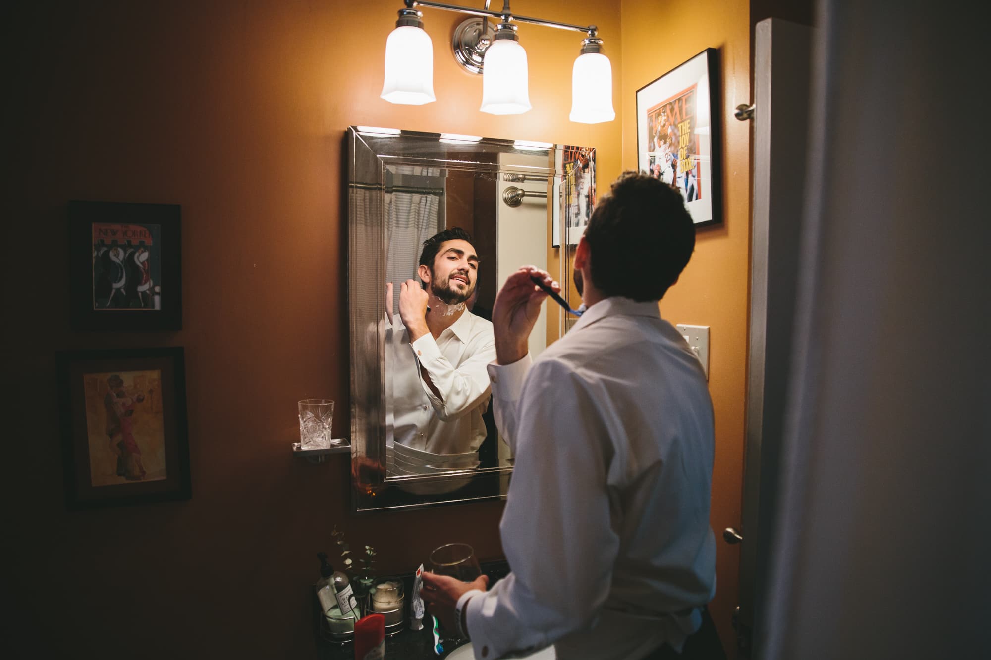 A documentary photograph of a groom shaving before his wedding at the State Room in Boston, Massachusetts