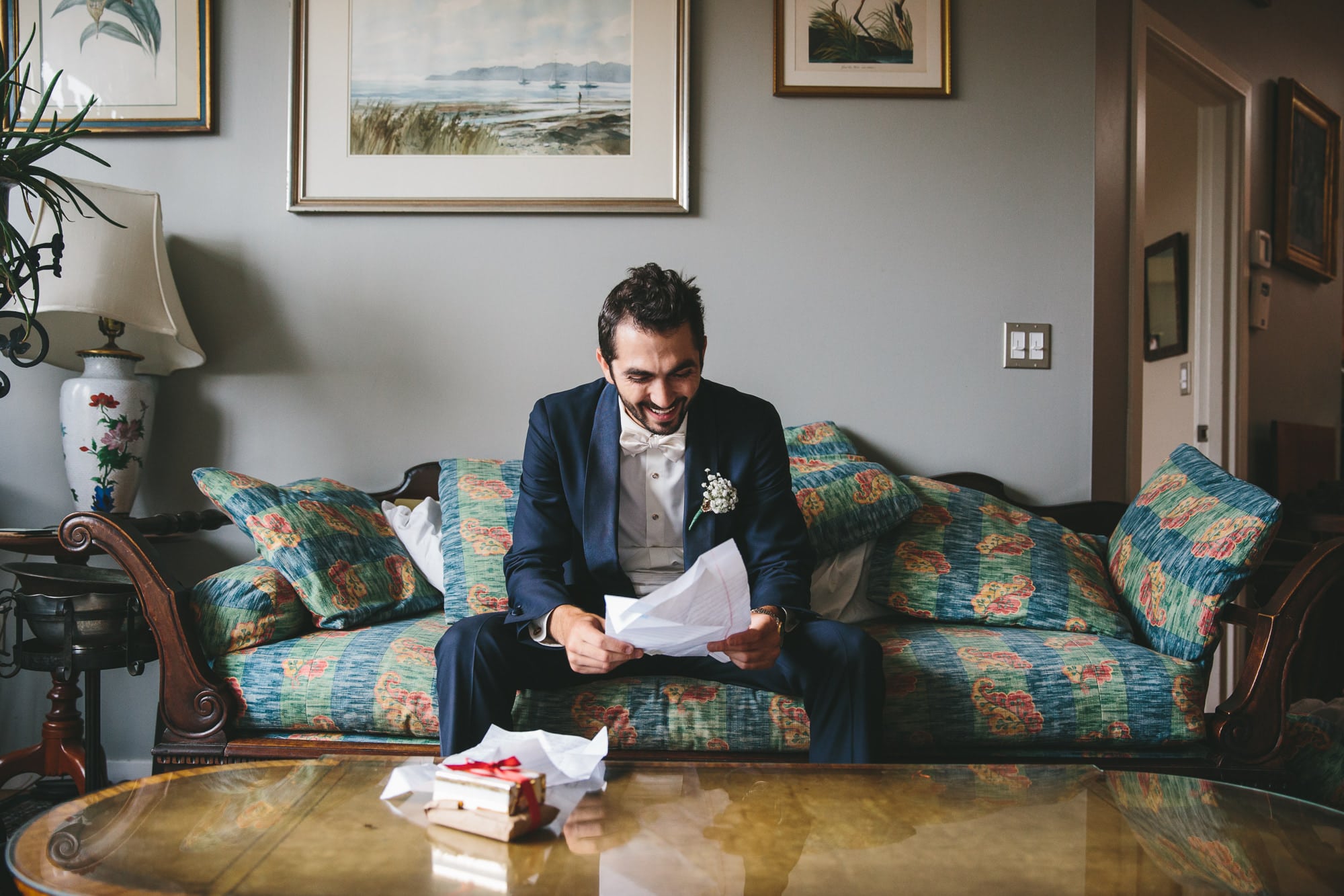 A documentary photograph of a groom reading a letter from his bride before his State Room wedding in Boston, Massachusetts