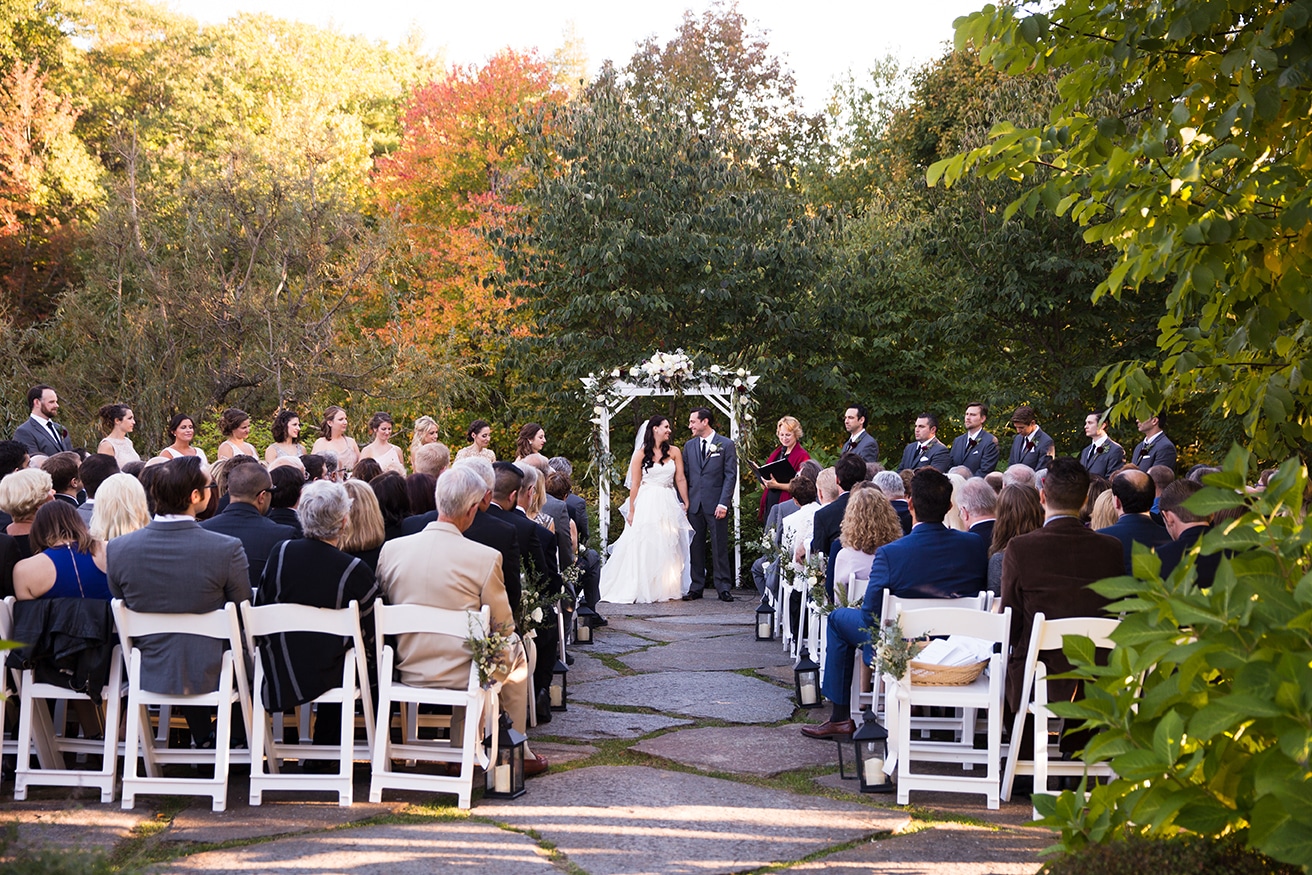 A documentary photograph of a bride and groom saying their vows during a Harrington Farm Wedding in Princeton, Massachusetts