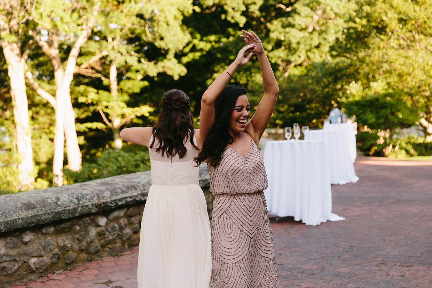 A documentary photograph of bridesmaids dancing during a Moraine Farm Wedding in Beverly, Massachusetts