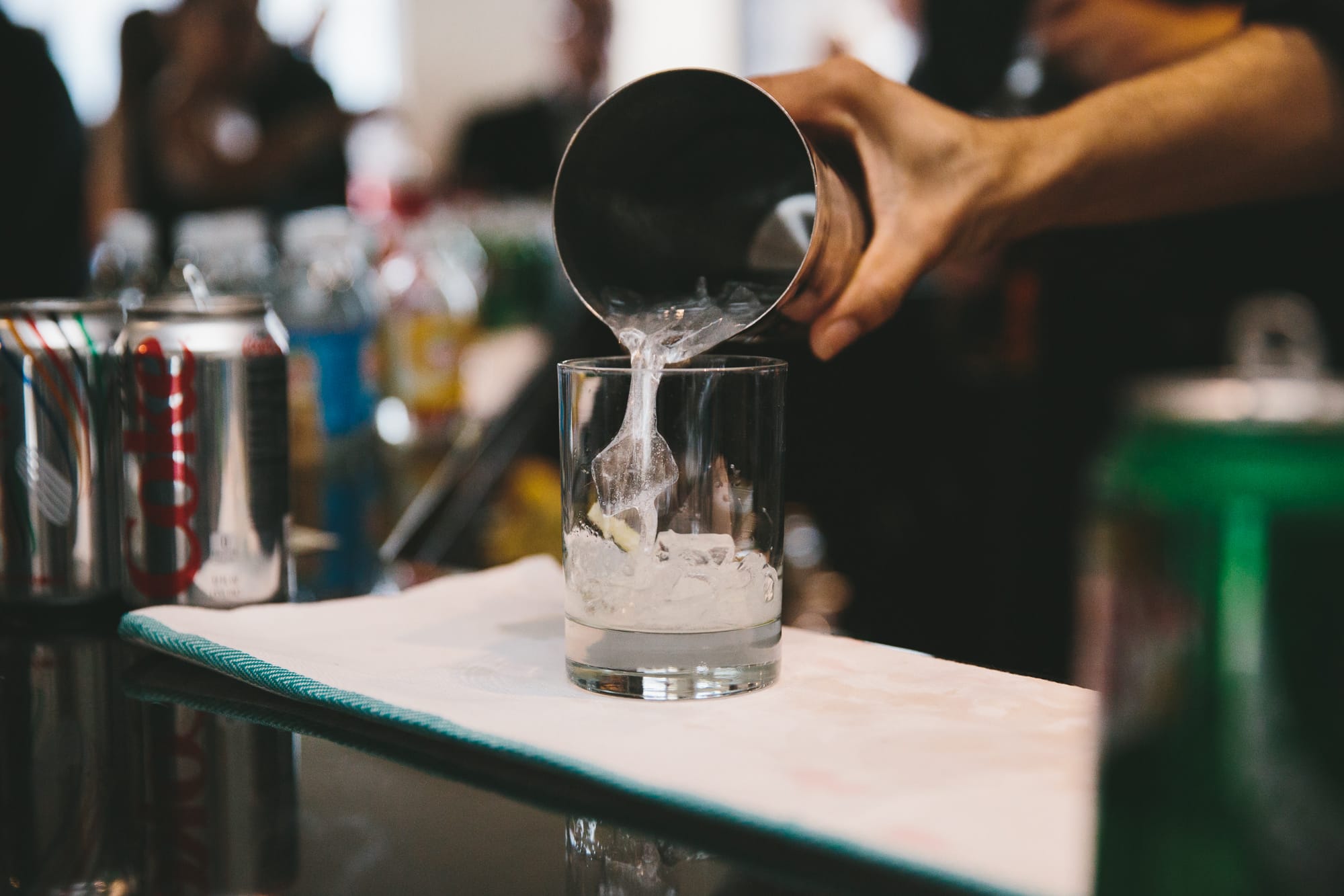 A documentary photograph of a cocktail being poured during a State Room Wedding