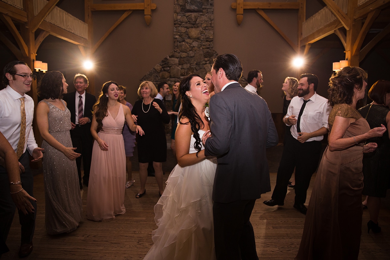 A documentary photograph of a bride and groom dancing with their guests during their Harrington Farm Wedding in Princeton, Massachusetts