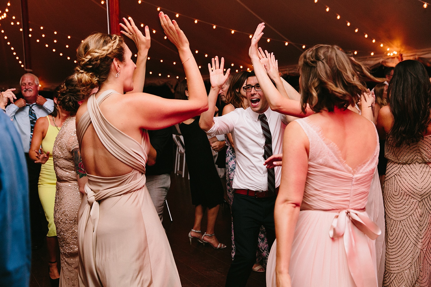A documentary photograph of guests dancing during a Moraine Farm Wedding in Beverly, Massachusetts
