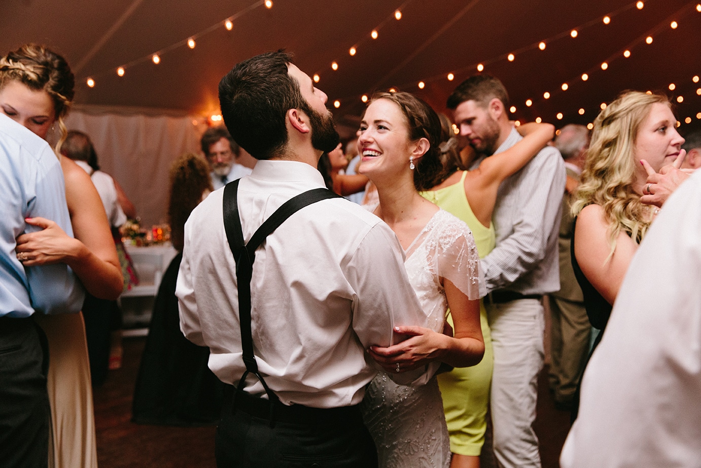 A documentary photograph of guests dancing during a Moraine Farm Wedding in Beverly, Massachusetts