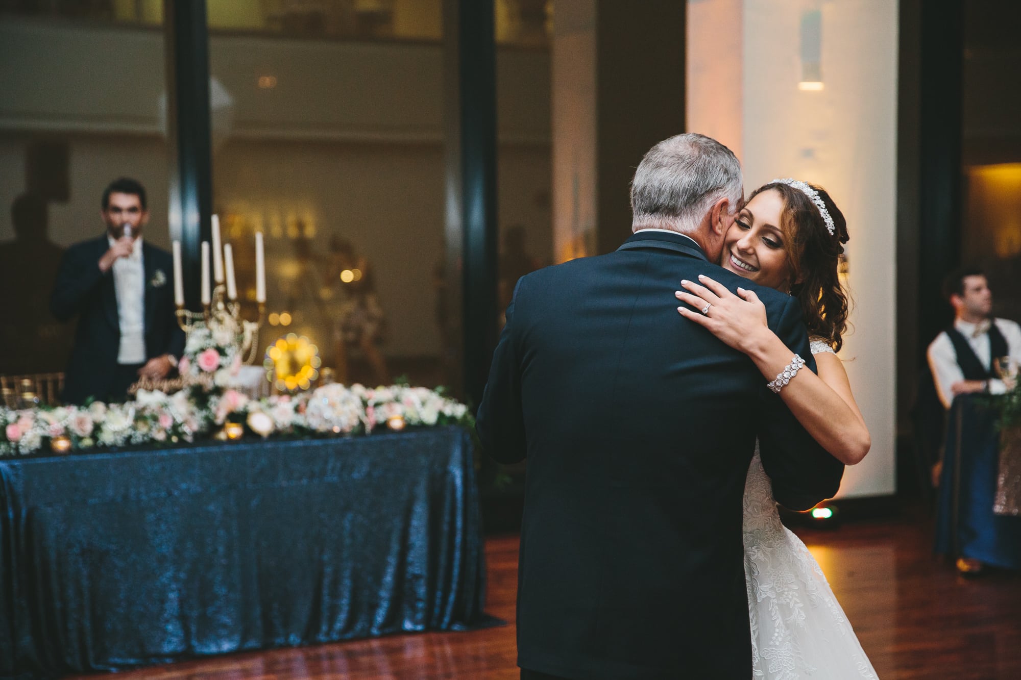 A documentary photograph of a bride dancing with her father during a State Room Wedding in Massachusetts