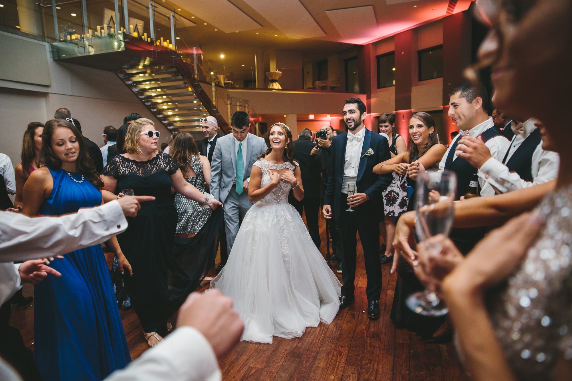A documentary photograph of guests dancing with the Bride and Groom during a State Room Wedding in Boston, Massachusetts