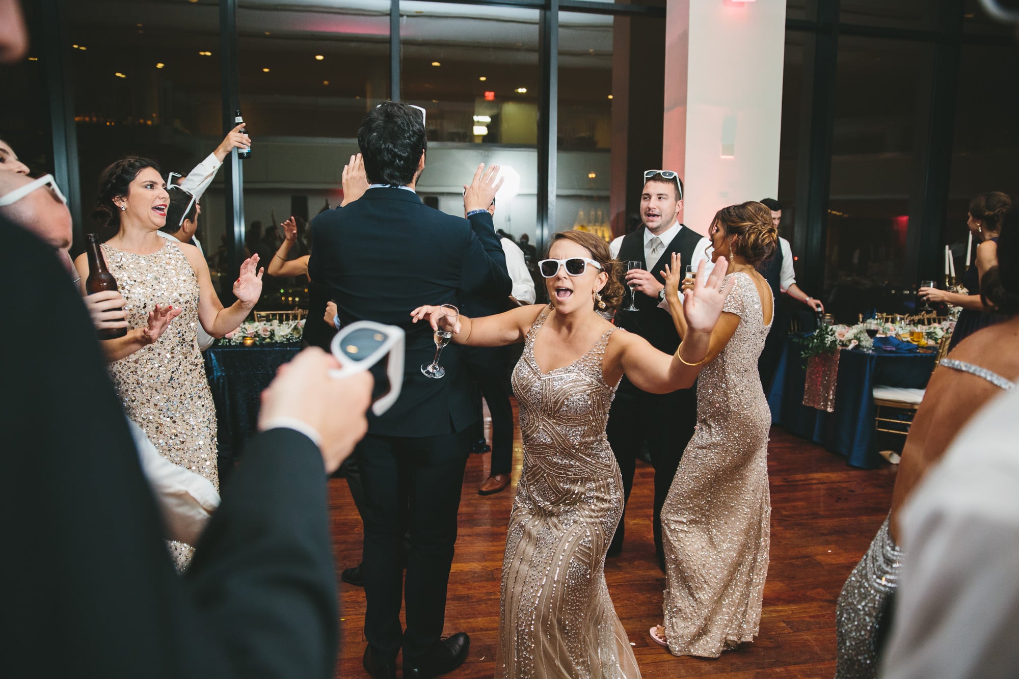 A documentary photograph of guests dancing during a State Room Wedding in Boston, Massachusetts
