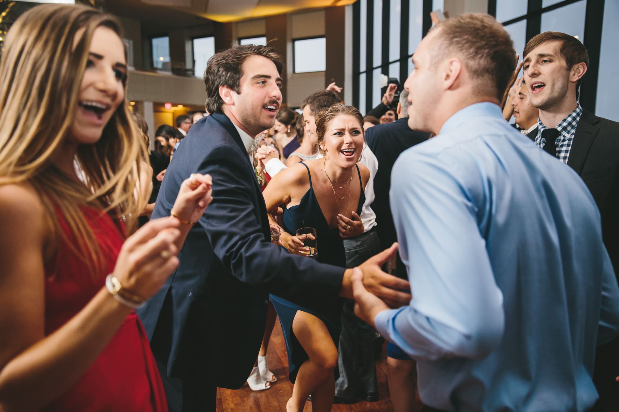 A documentary photograph of guests dancing at a State Room Wedding in Boston, Massachusetts