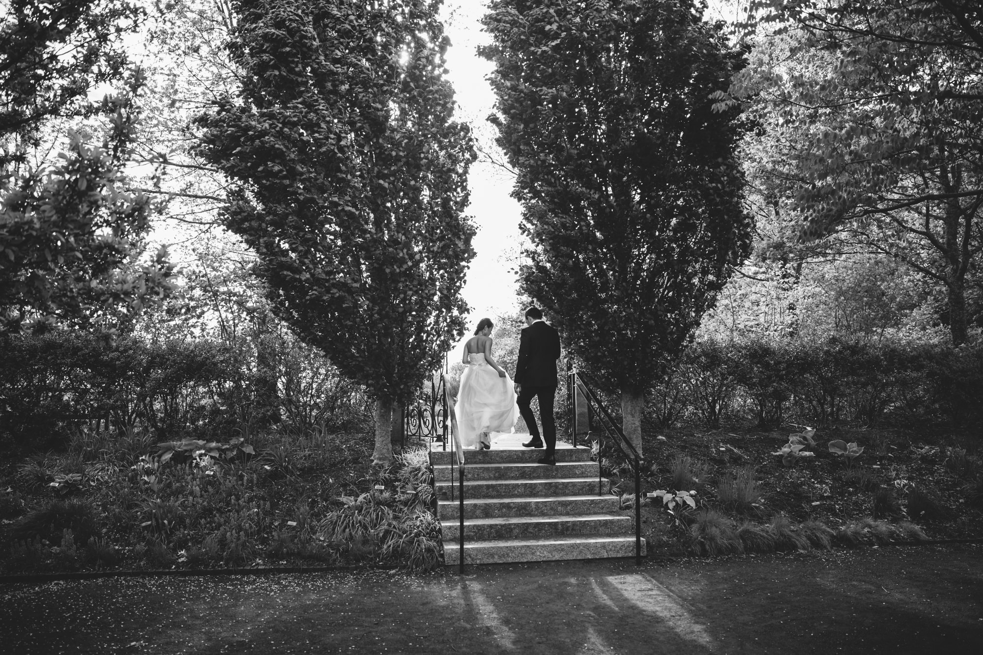 A documentary photograph of a bride and groom walking to their Tower Hill Wedding in Boylston, Massachusetts