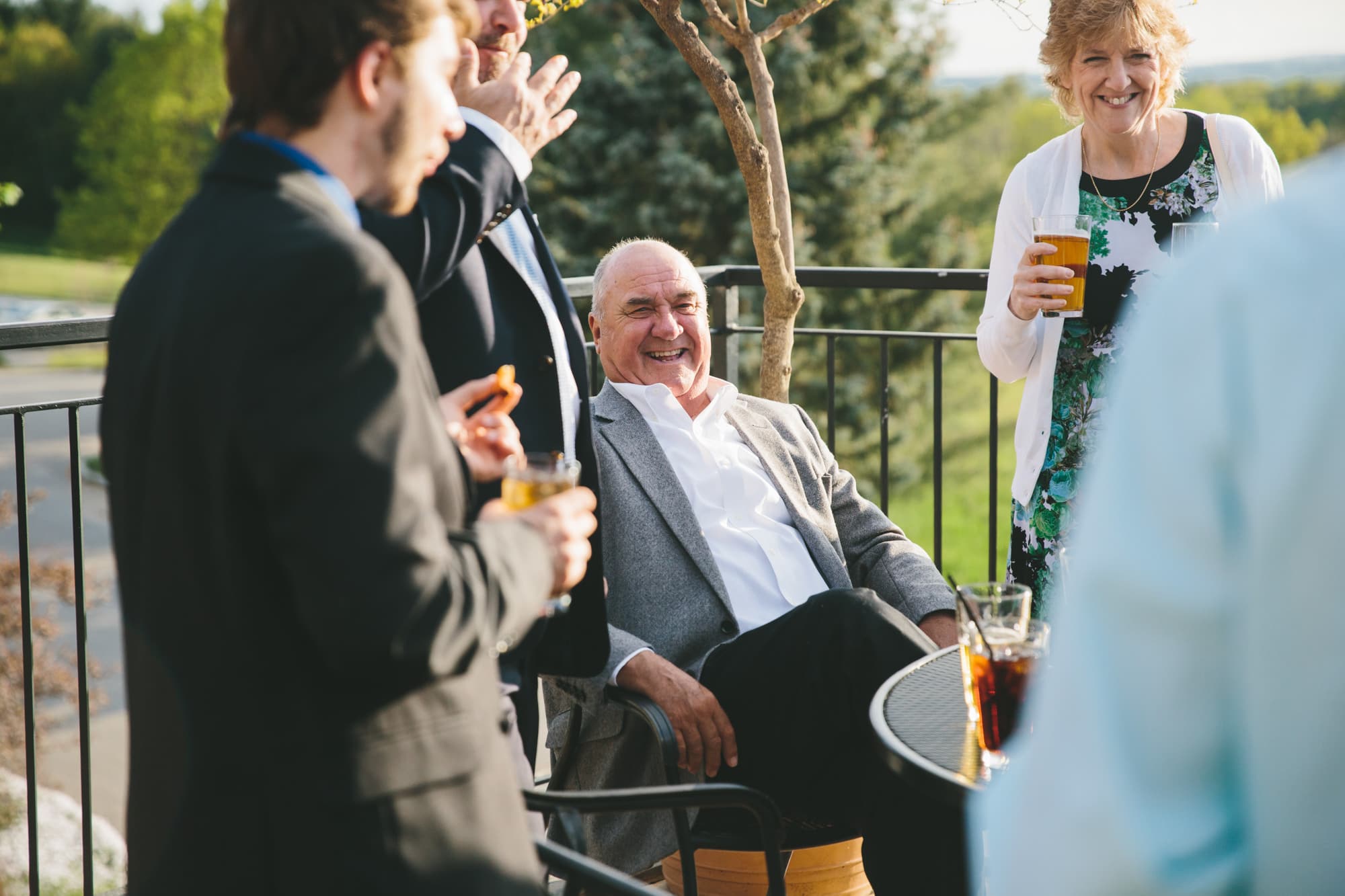 A documentary photograph of guests laughing during a Tower Hill Wedding in Boylston, Massachusetts