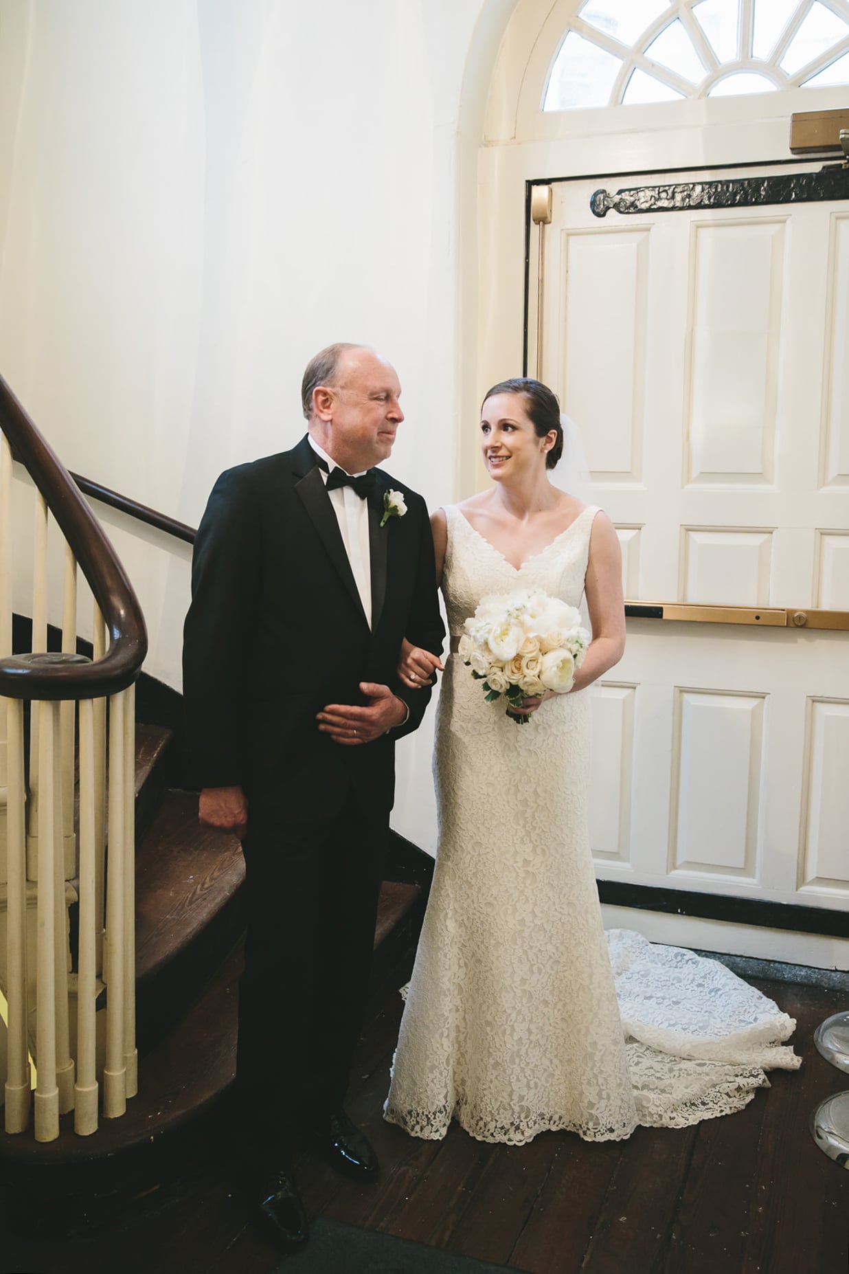 A documentary photograph of a bride and her father before they walk down the aisle of the Old South Meeting House before their State Room Wedding reception