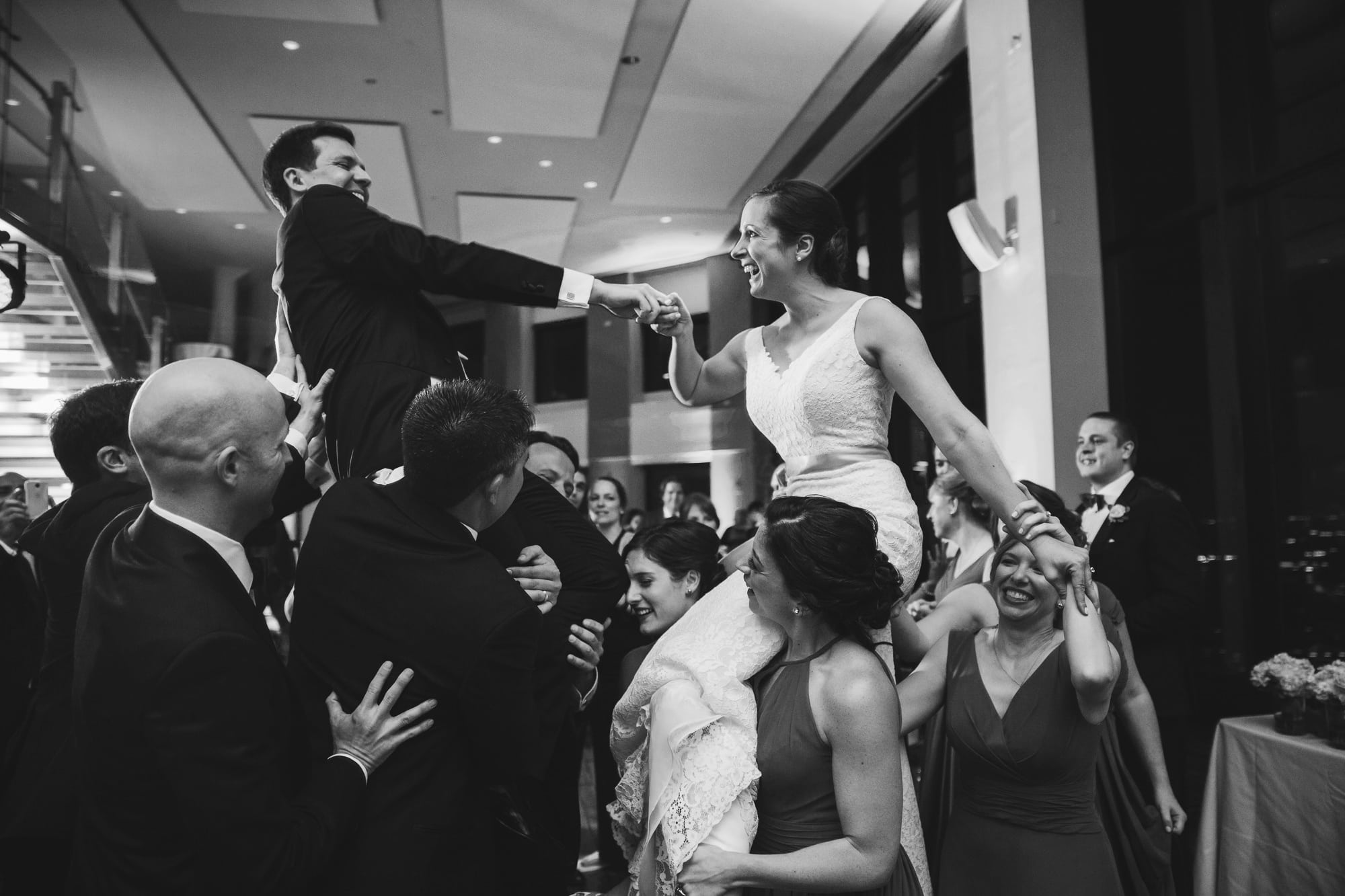 A documentary photograph of a bride and groom dancing at their State Room Wedding
