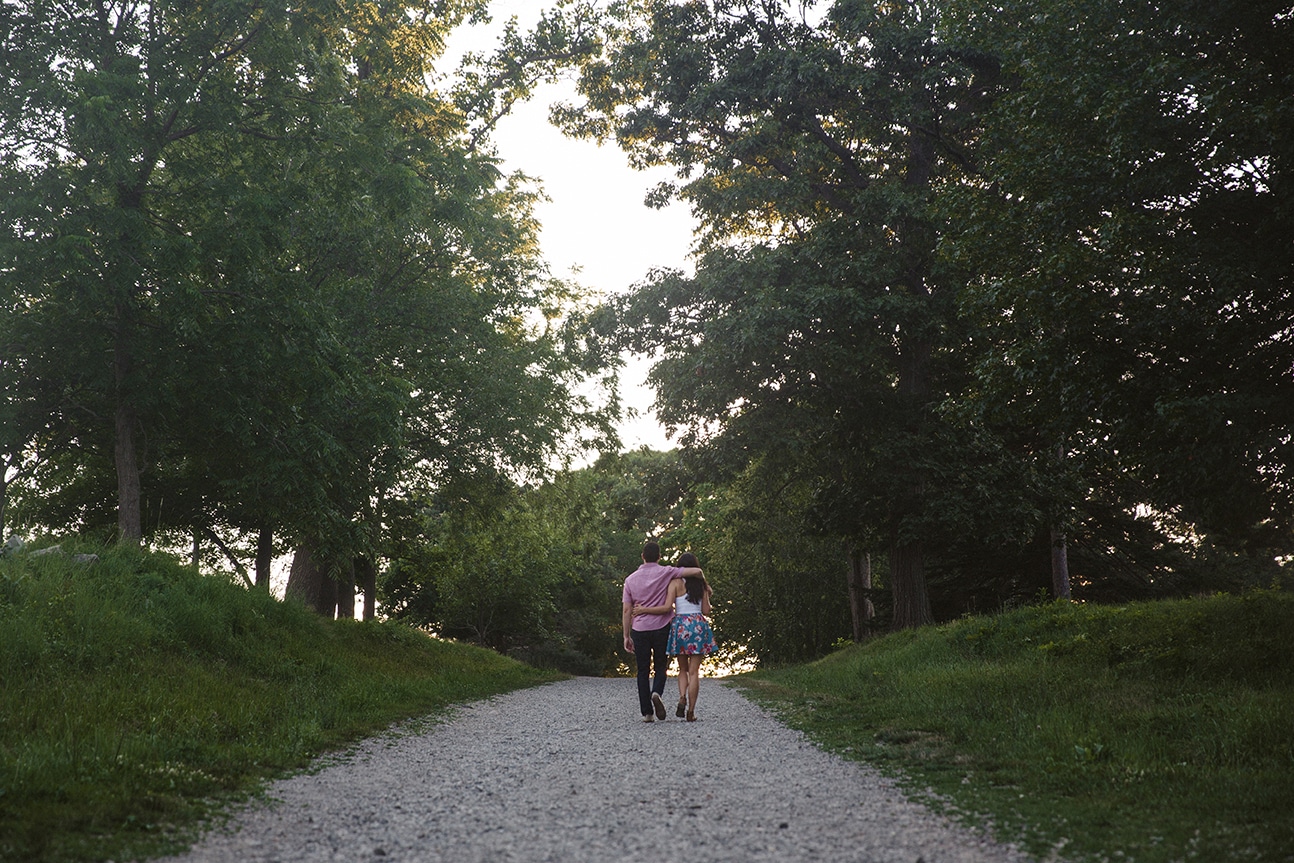 A documentary photograph of a couple walking together during their World's End Engagement Session in Hingham, Massachusetts