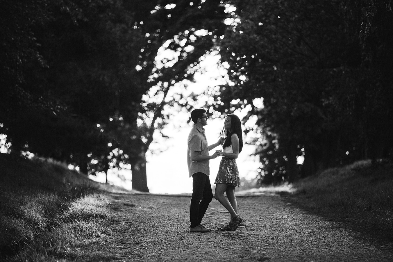 A couple hold hands during their engagement session at the World's End in Hingham, Massachusetts