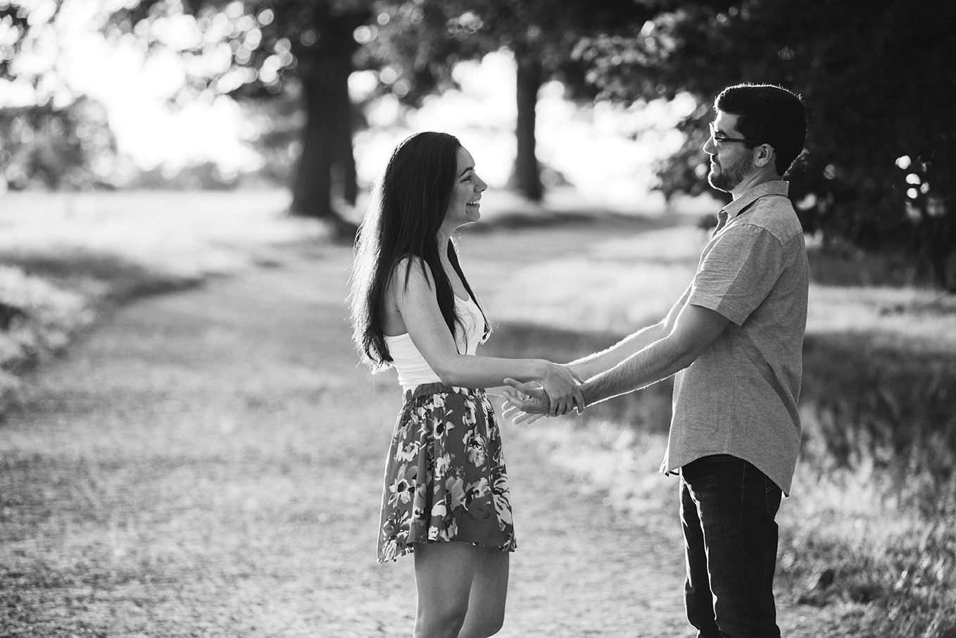 A documentary photograph of a couple holding hands during their World's End Engagement Session in Hingham, Massachusetts