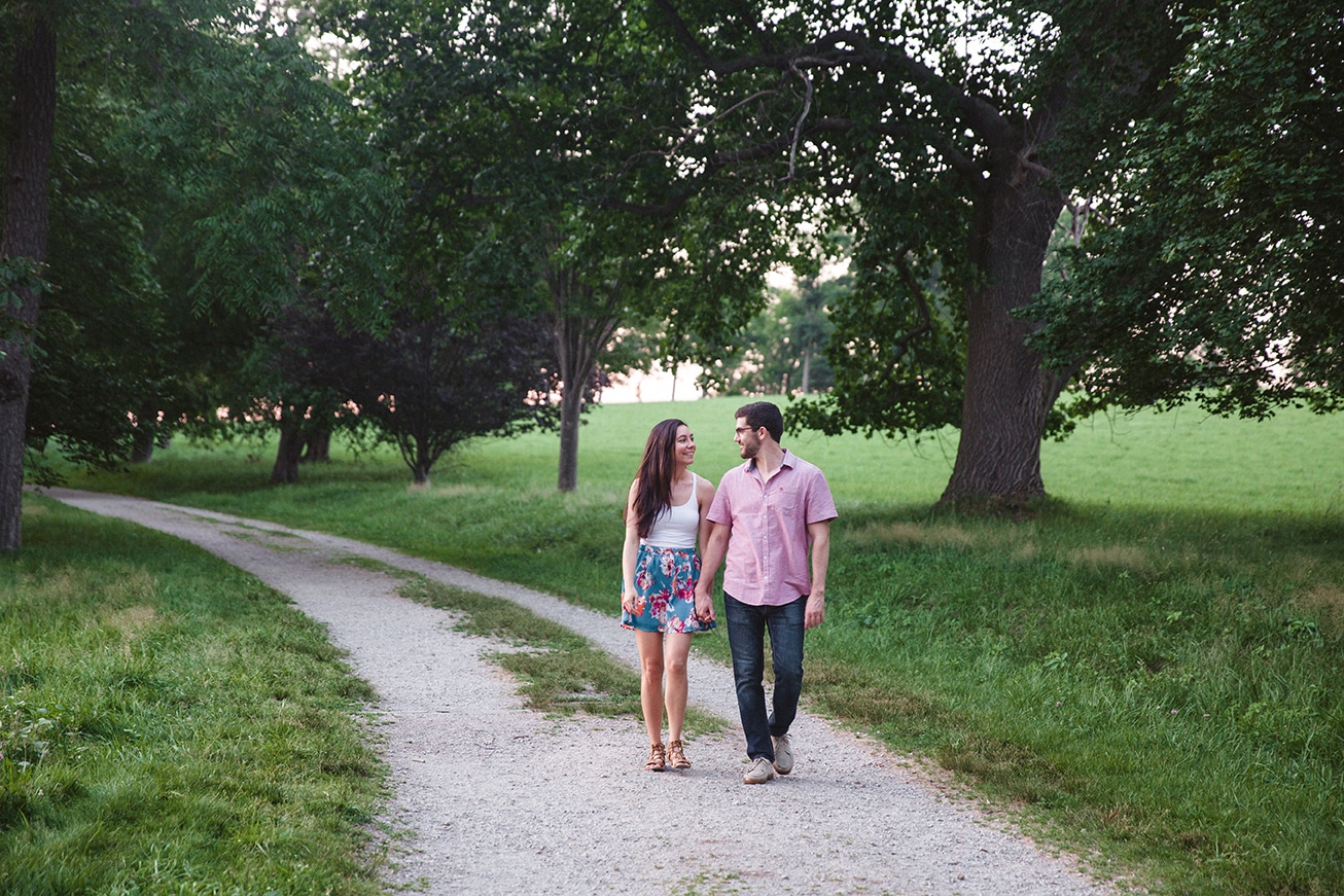 A documentary photograph of a walking together during their engagement session at the World's End in Hingham, Massachusetts