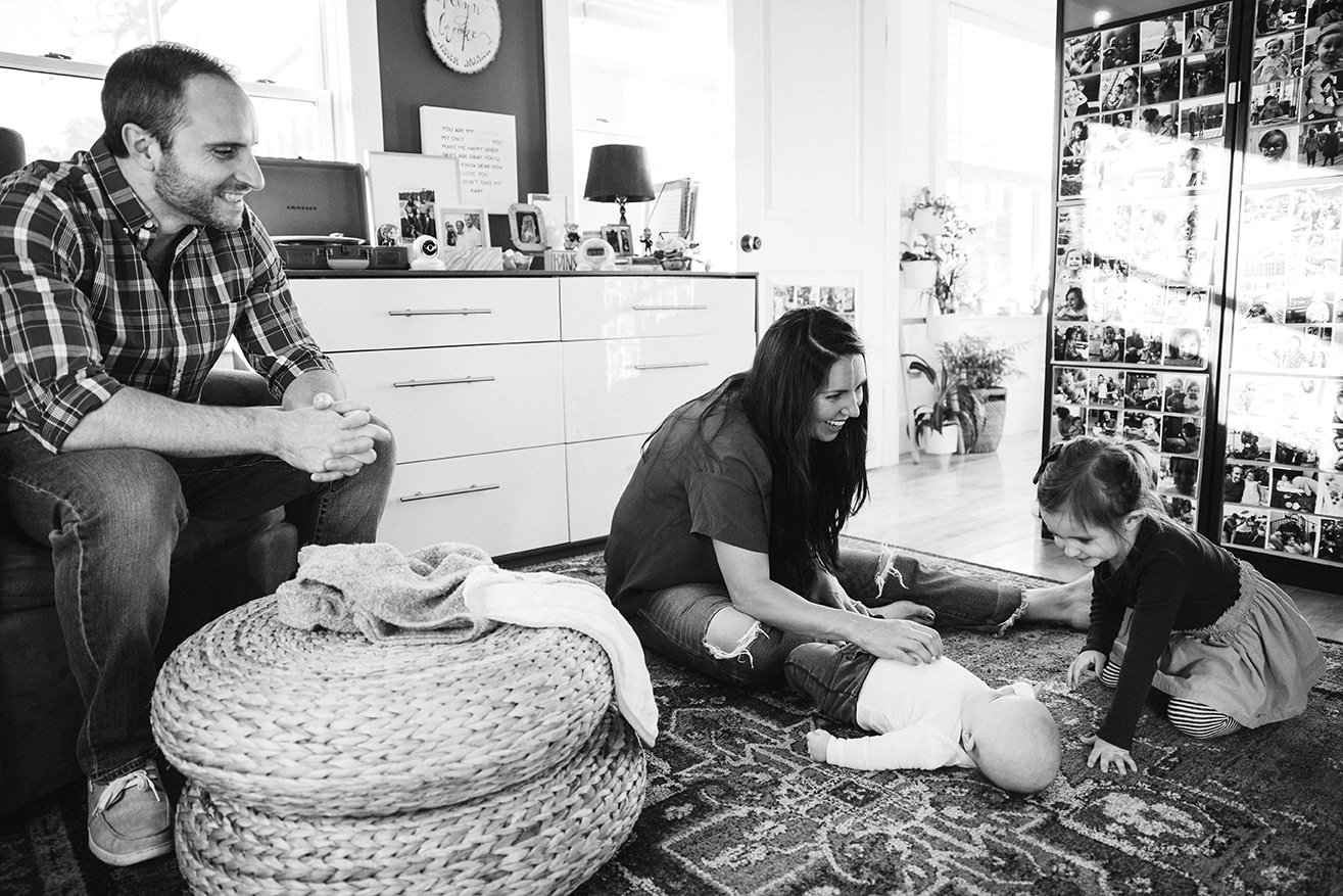A documentary photograph of a family hanging out in their home during a lifestyle family session in Boston, Massachusetts