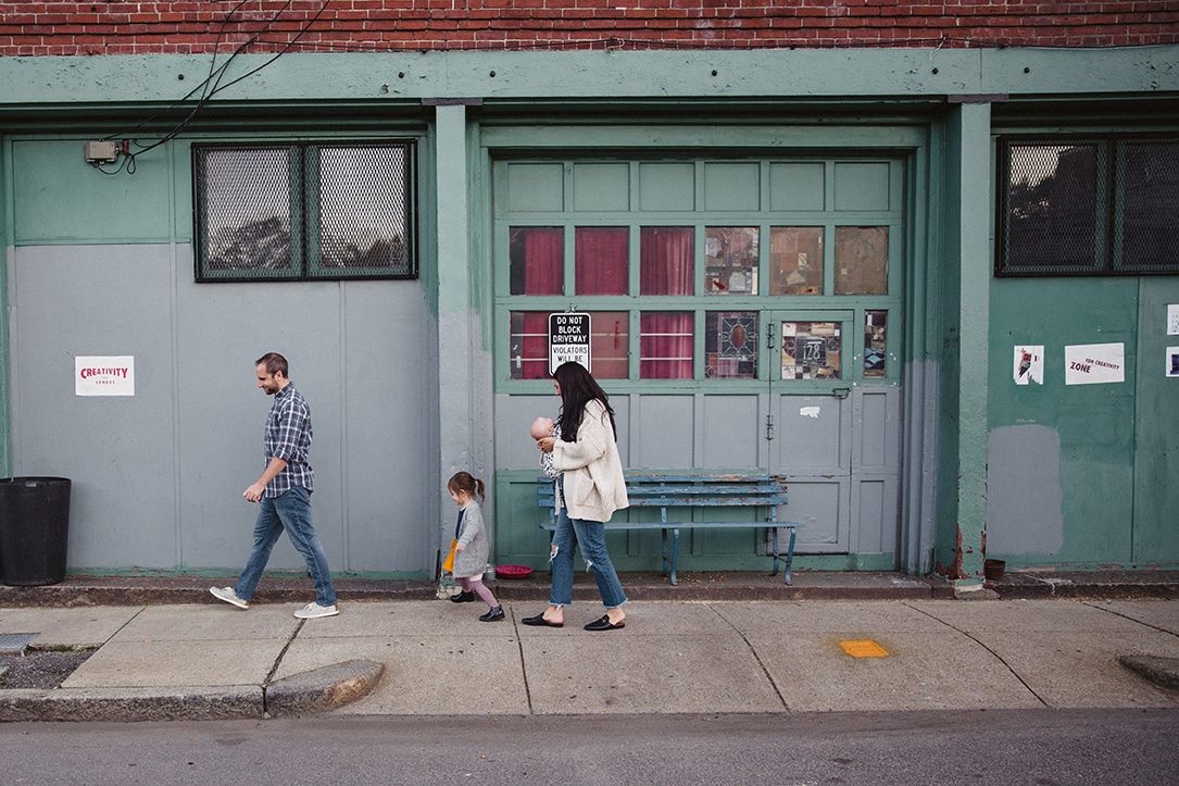 A documentary photograph of a family walking to the playground during their in home family lifestyle session in Boston, Massachusetts