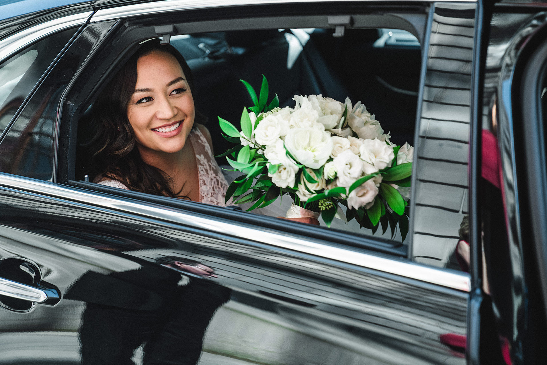 A documentary photograph of a bride in the car on the way to her Fairmont Copley wedding in Boston