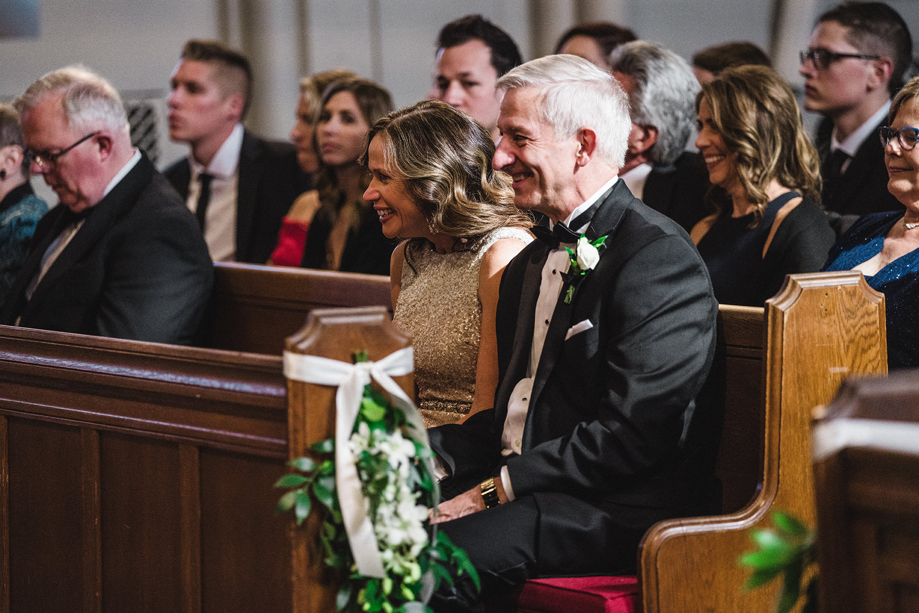 A documentary photograph of the grooms parents laughing during their Boston Wedding Ceremony at Marsh Chapel
