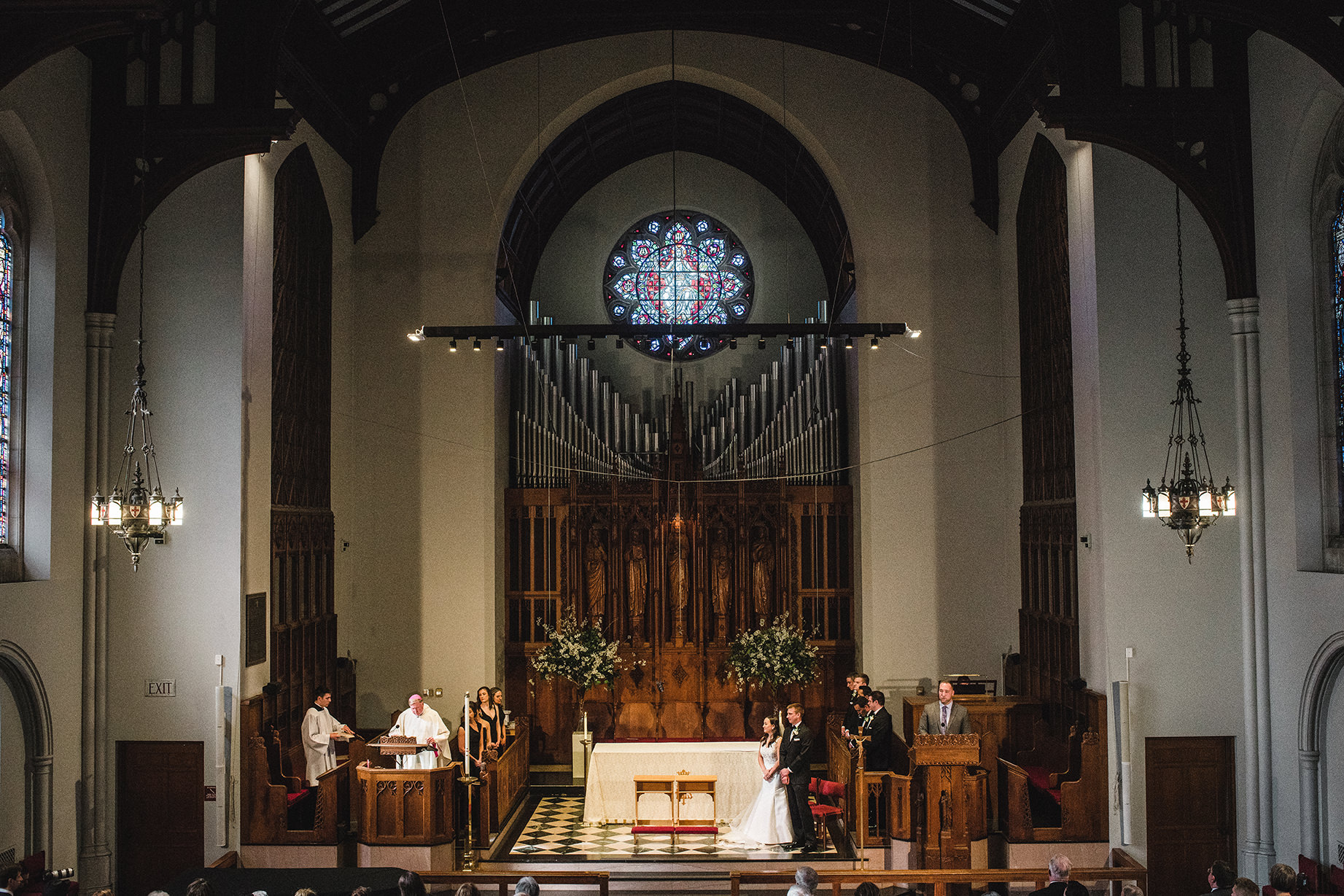 A documentary photograph of a bride and groom during their Boston Wedding Ceremony at Marsh Chapel