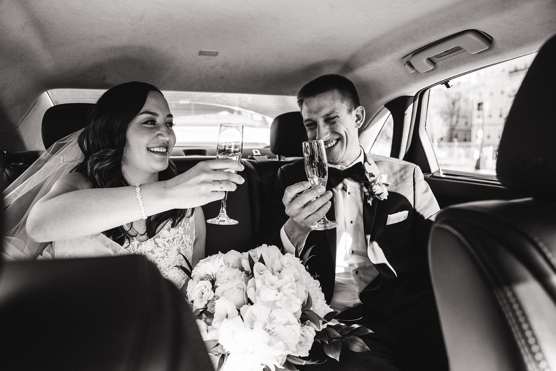 A documentary photograph of the bride and groom in the car together when just married at marsh chapel in Boston